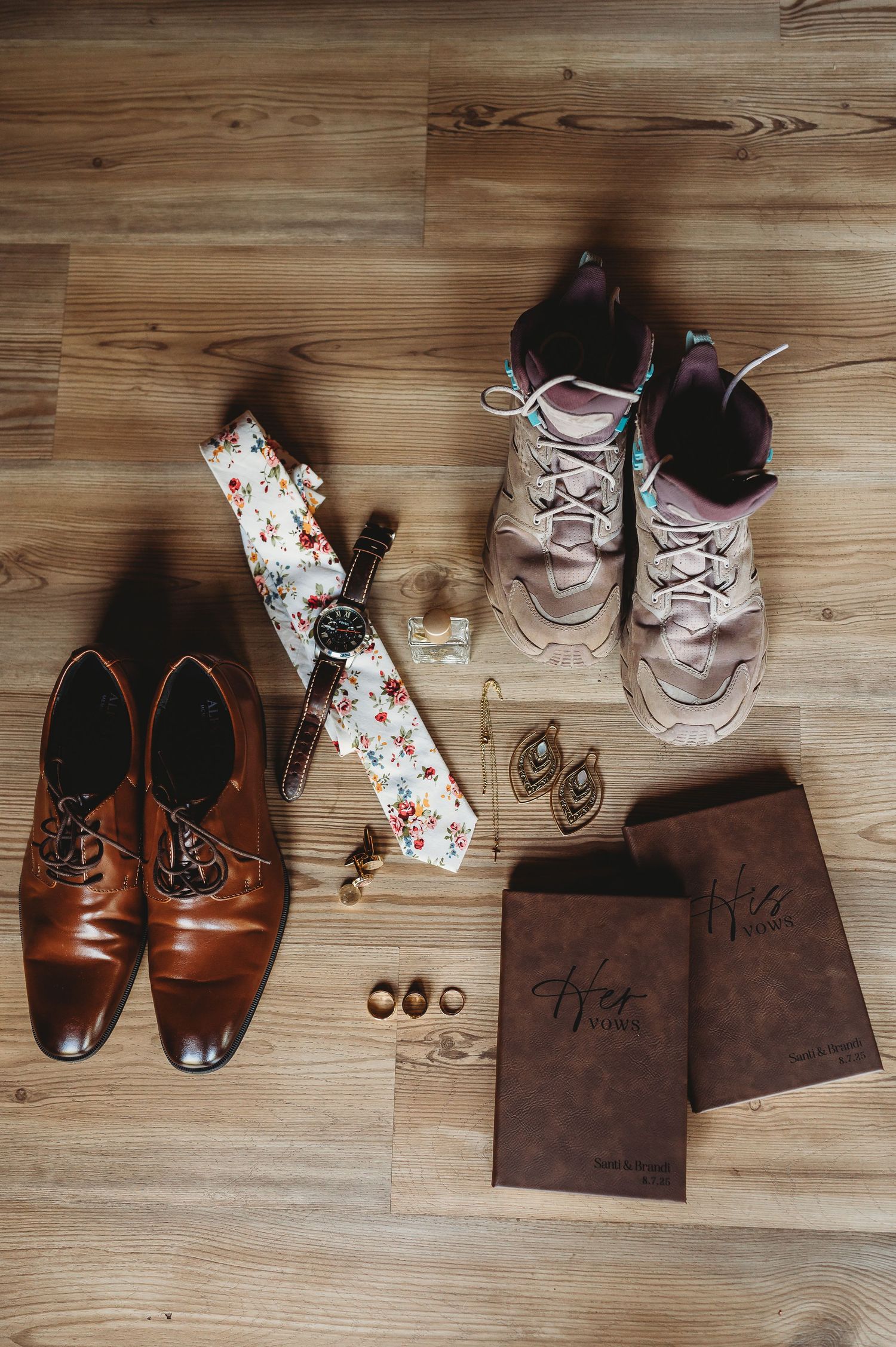 Collection of brown leather dress shoes and accessories arranged on a wooden floor in progressive sequence.