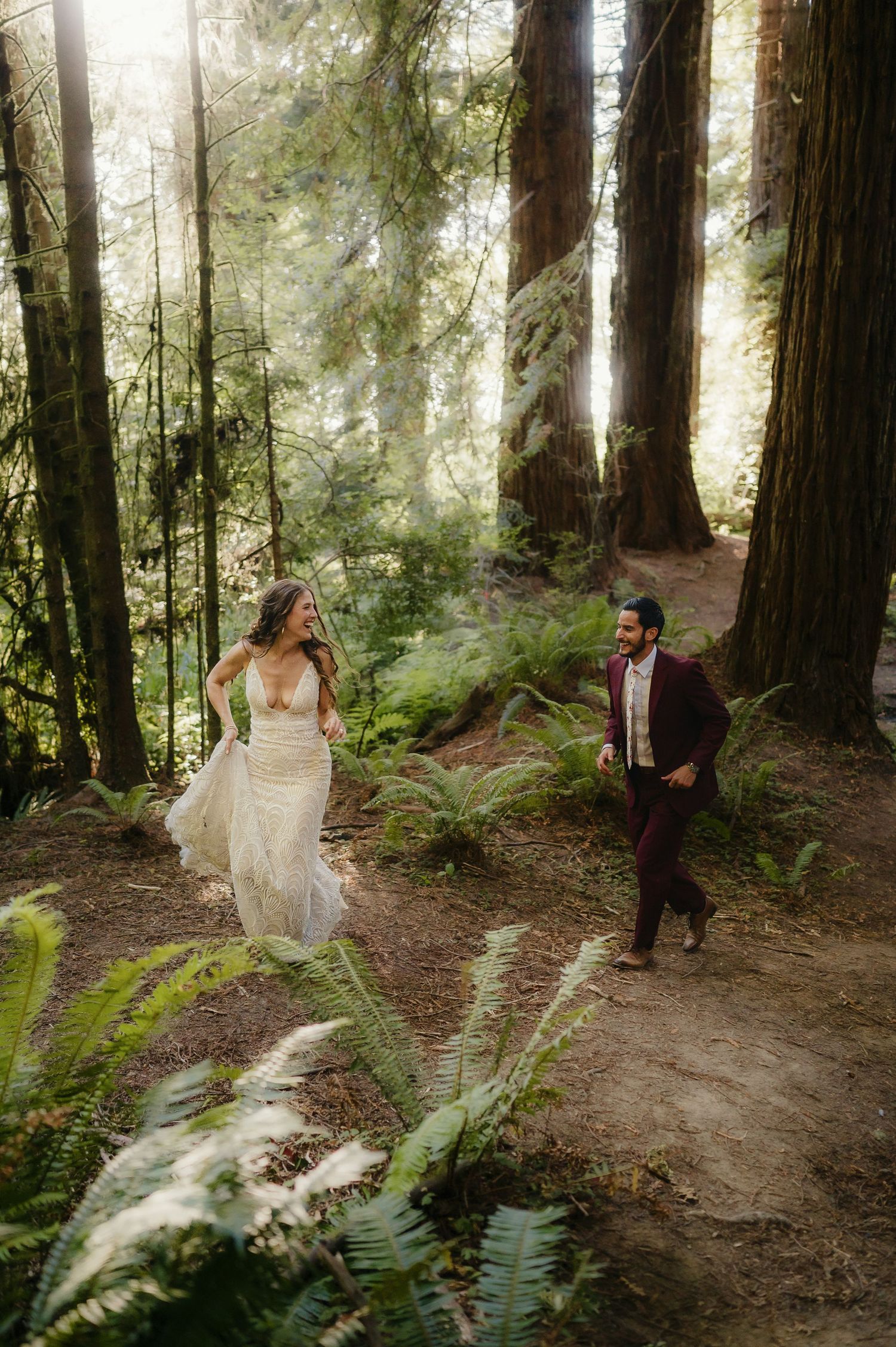 Romantic forest photoshoot amongst tall redwood trees with sunlight filtering through the canopy.