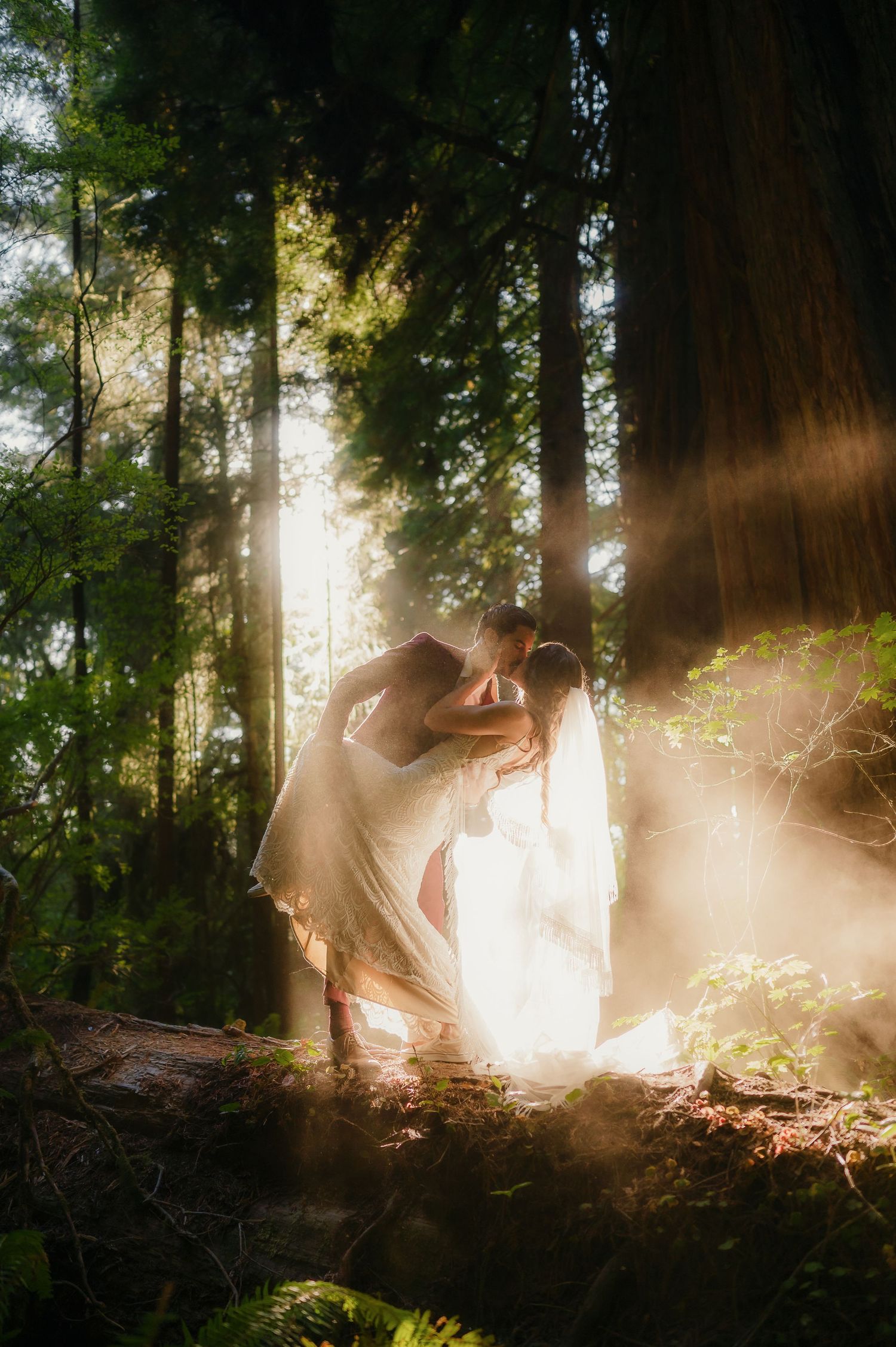 A dreamy forest wedding photoshoot with ethereal sunlight streaming through tall trees creating magical silhouettes.