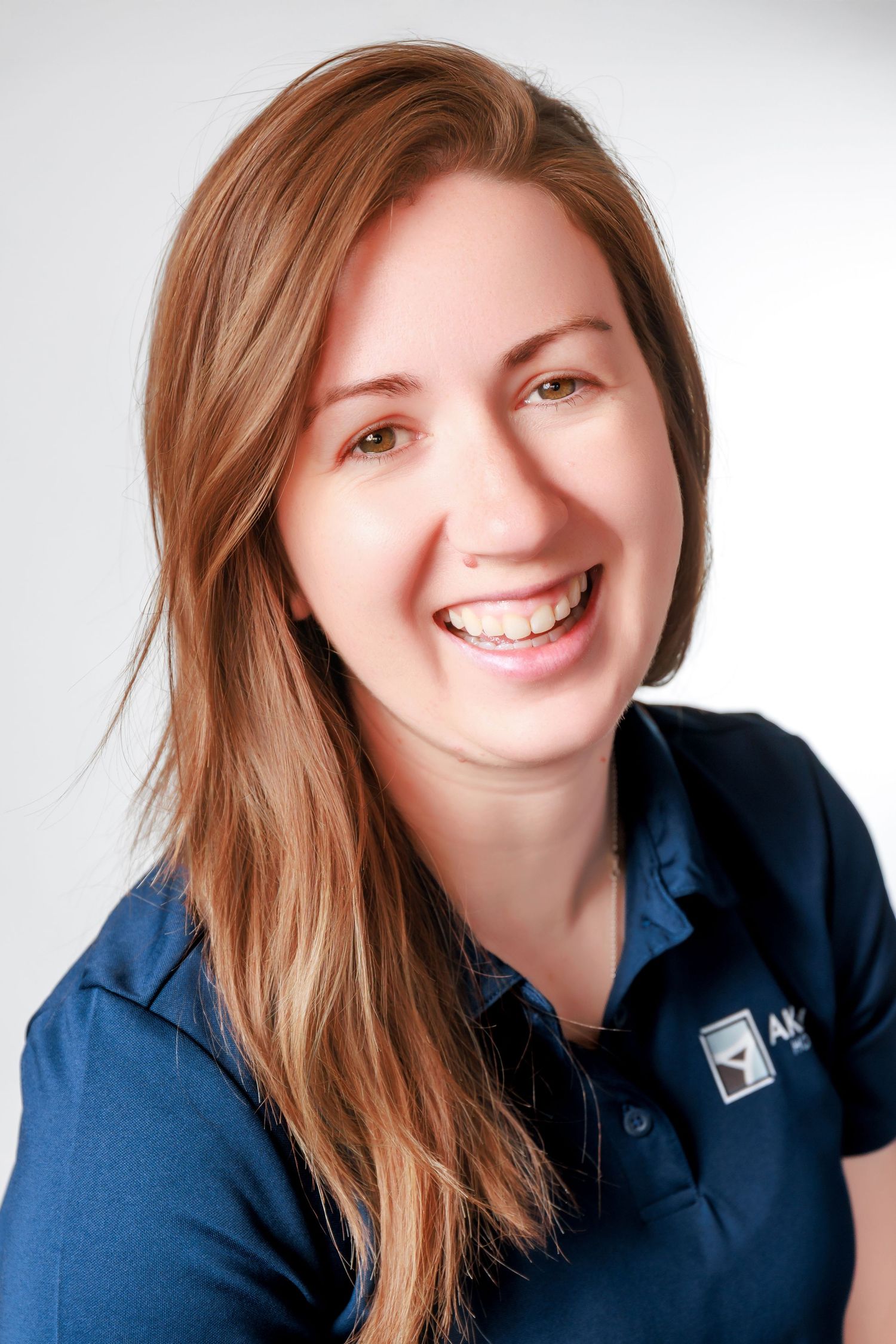 Professional headshot series showing expressions in navy blue business attire against white background.