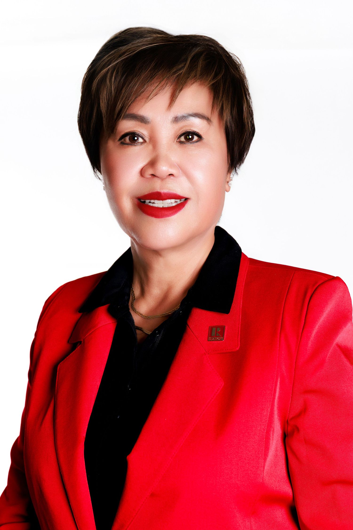 A series of four headshots showing someone wearing a bright red blazer and black top against a white background.