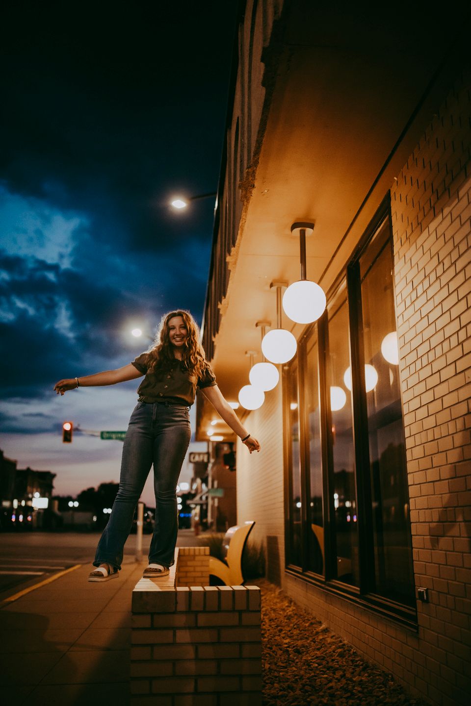 Nighttime portrait with dramatic lighting and moody sky.