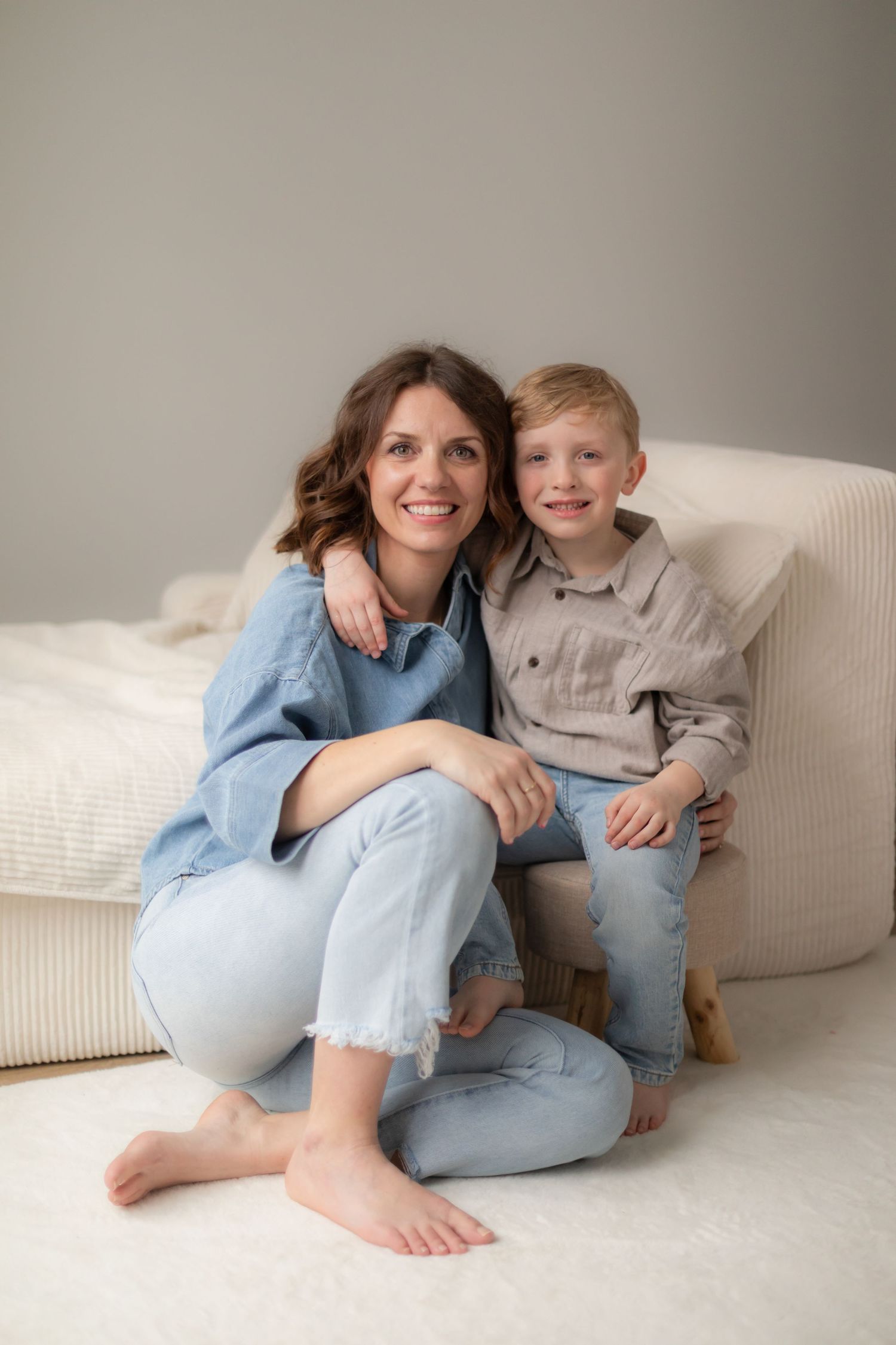 Candid lifestyle photos showing tender moments between family members on a white sofa.