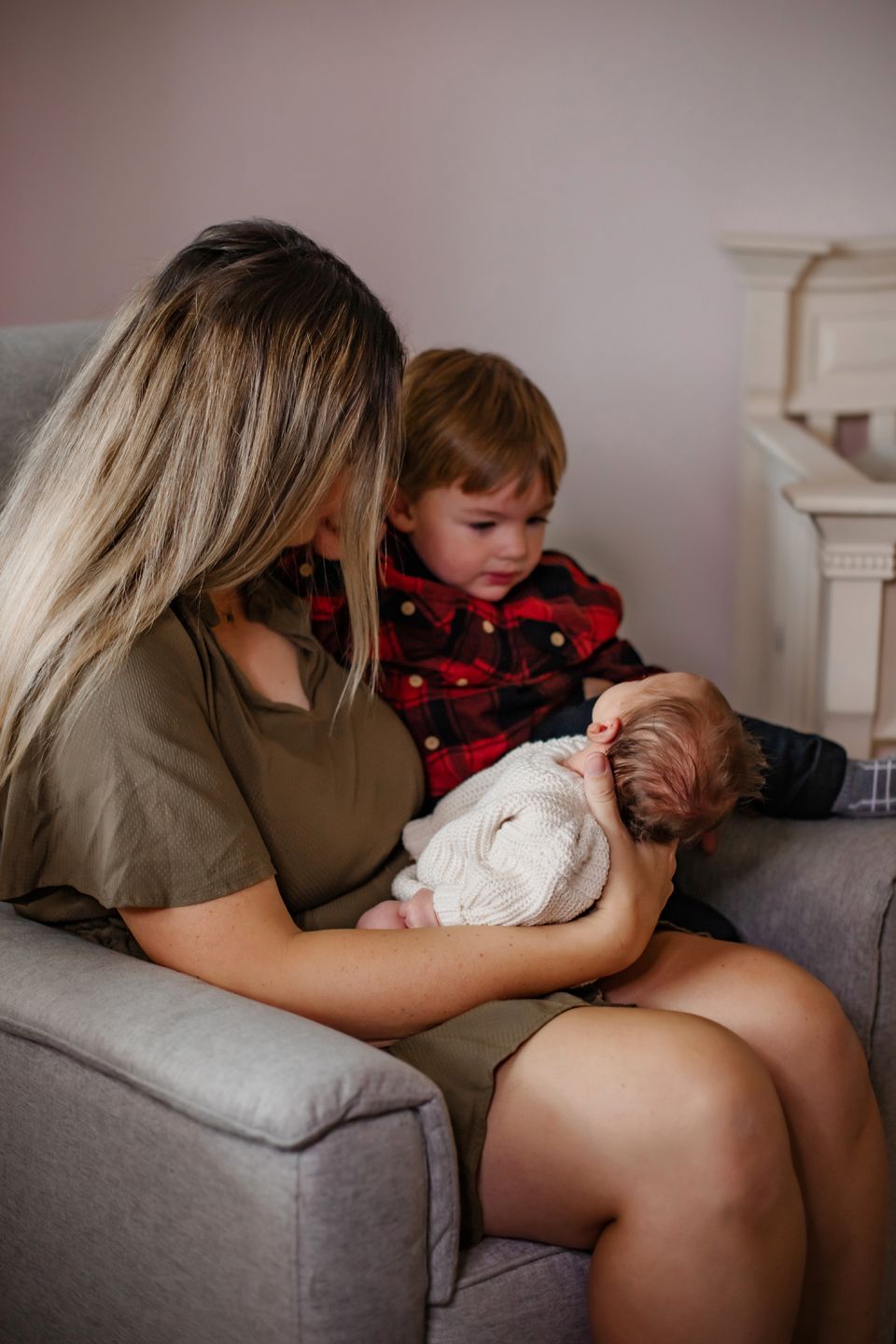 A peaceful moment in a nursery with buffalo plaid and neutral tones.