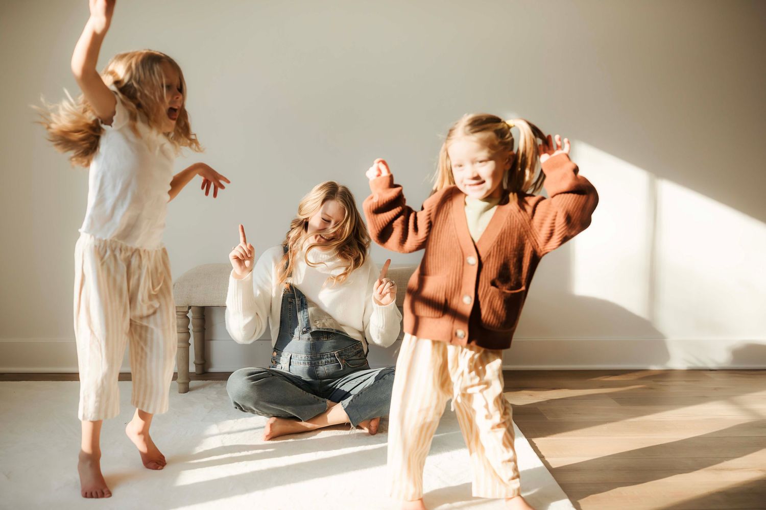 A series of contemporary dance movements captured in a sequence showing fluid motion and graceful poses in a sunlit studio.