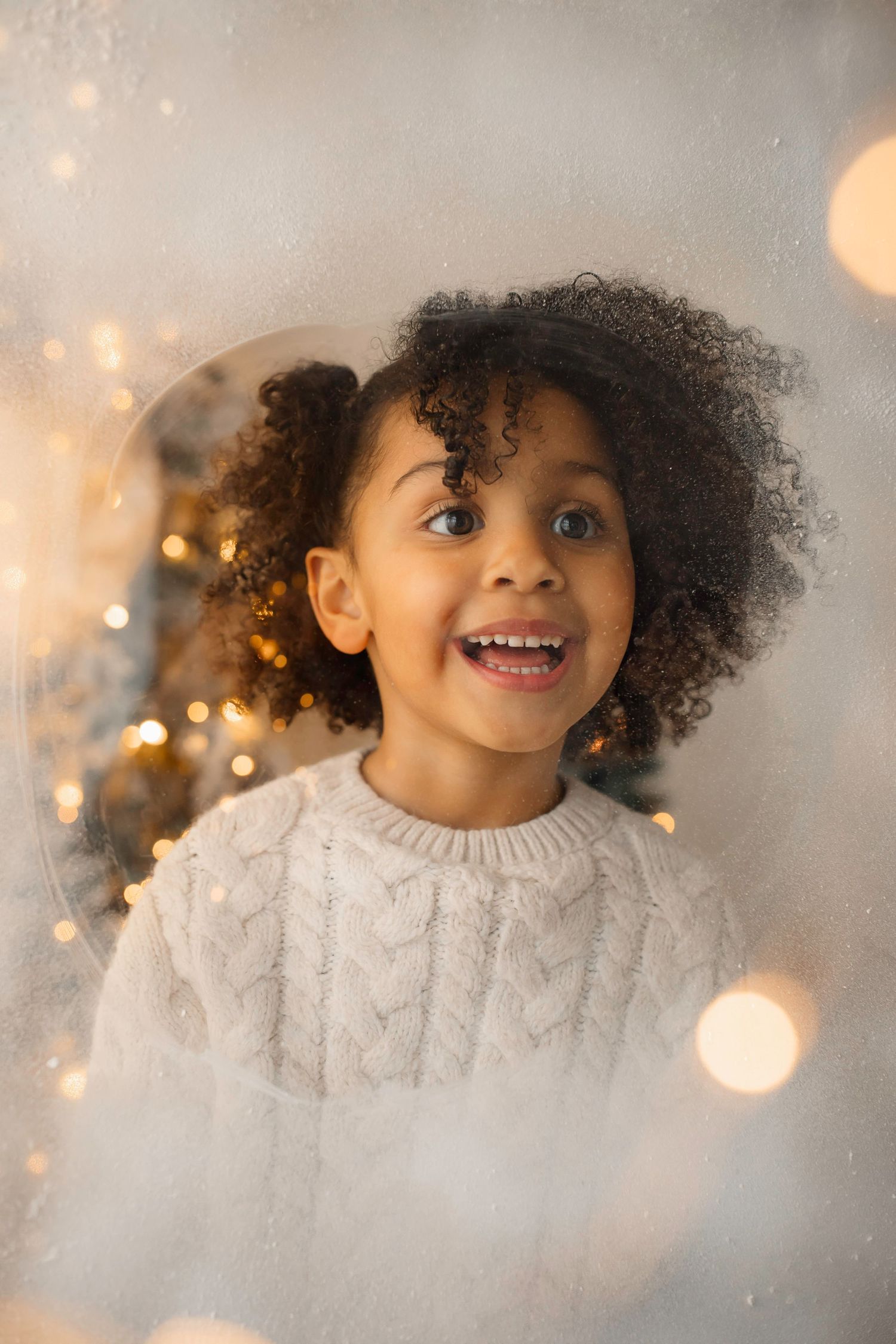 Dreamy holiday portrait with bokeh lights and decorated Christmas trees.