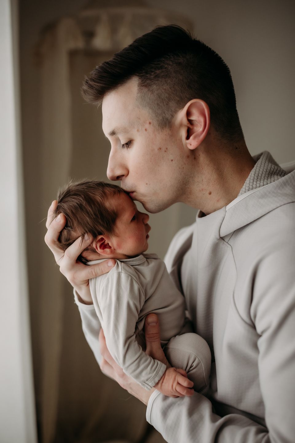 Tender moment captured in soft window light.