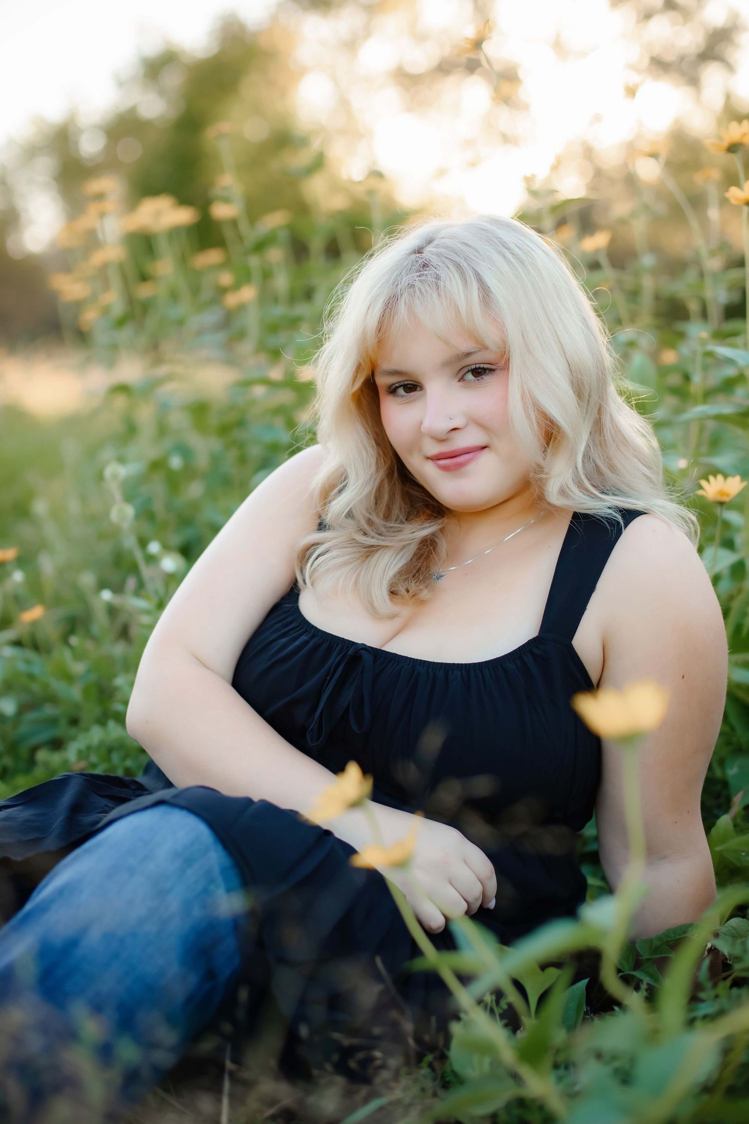 Summer portrait in field with yellow wildflowers.