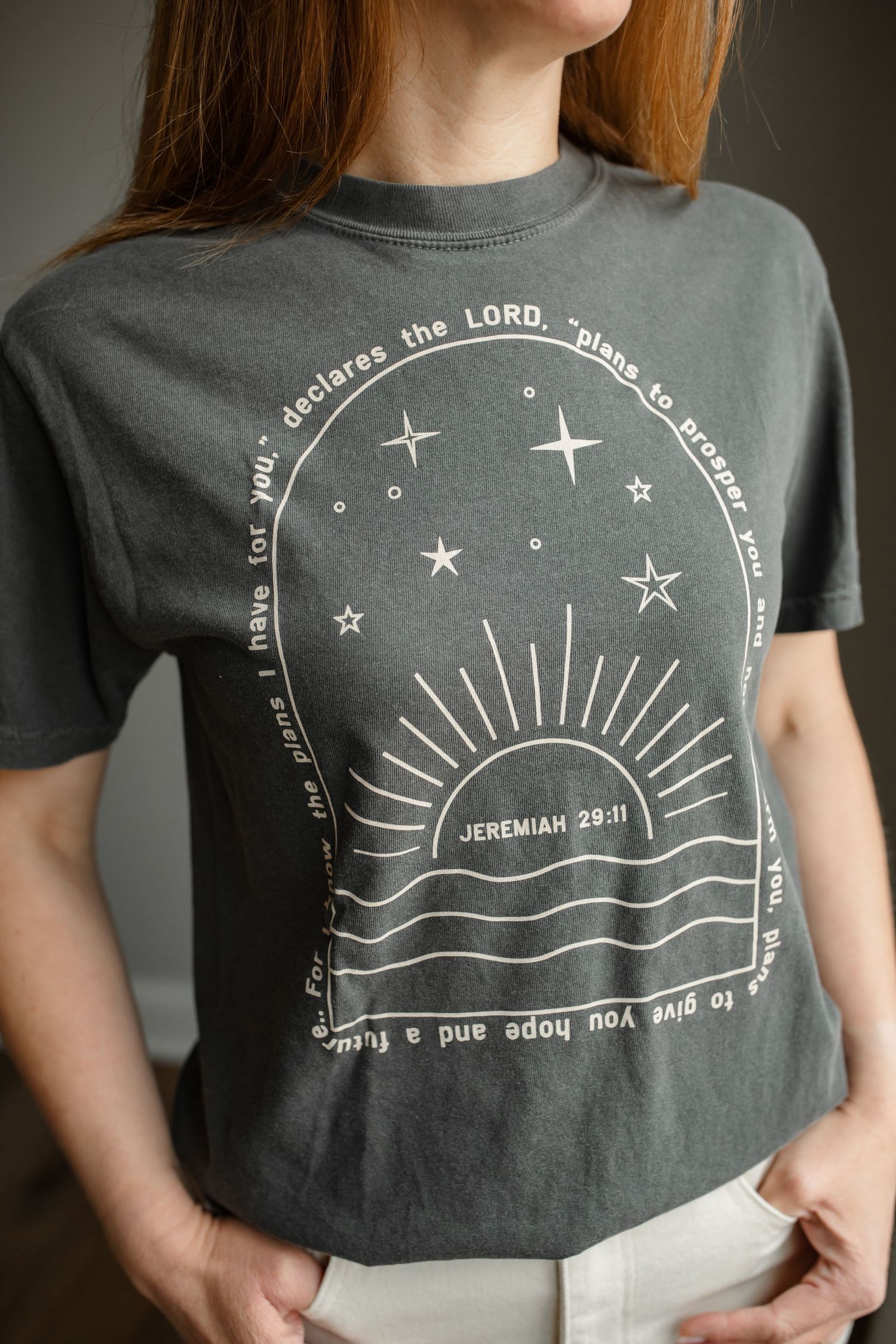 Gray t-shirt with spiritual sunset design and bible verse text in circular pattern.