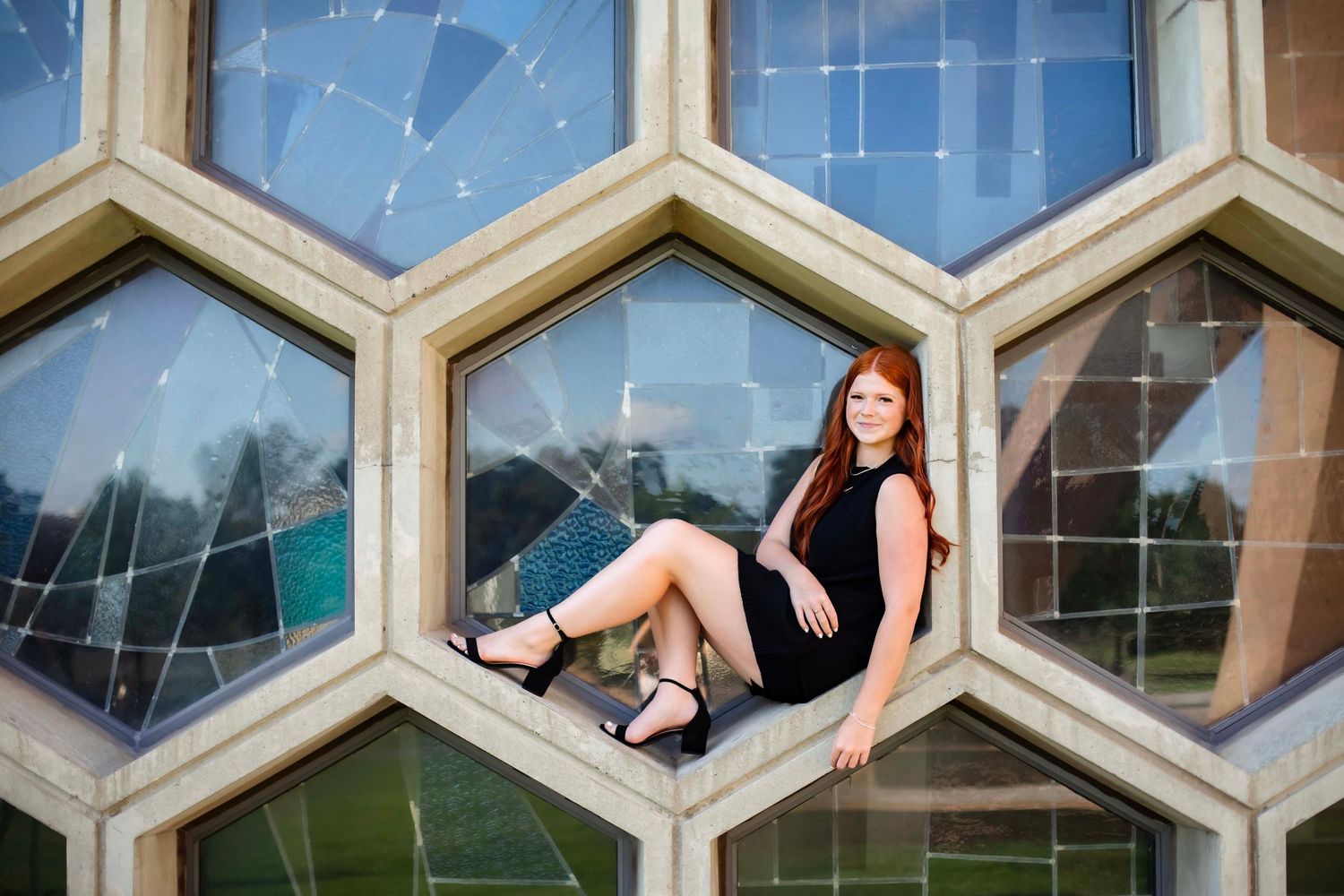 Creative portrait in geometric hexagonal window structure with urban architectural elements.