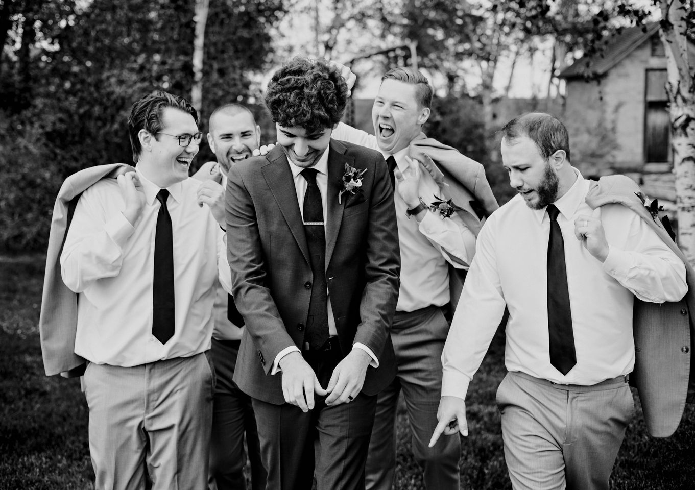 Candid black and white photo capturing joyful laughter during wedding celebrations in Minnesota.