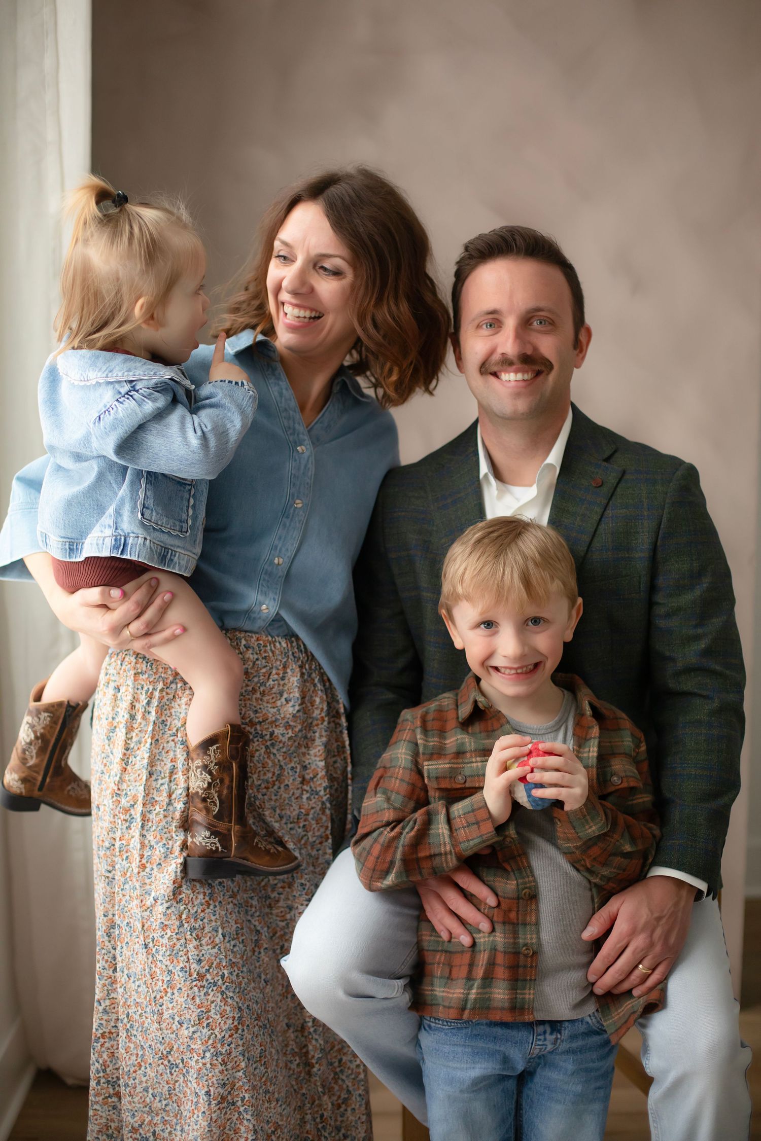 A family portrait series showing candid moments of parents and children laughing with Willow & Wren Photography.