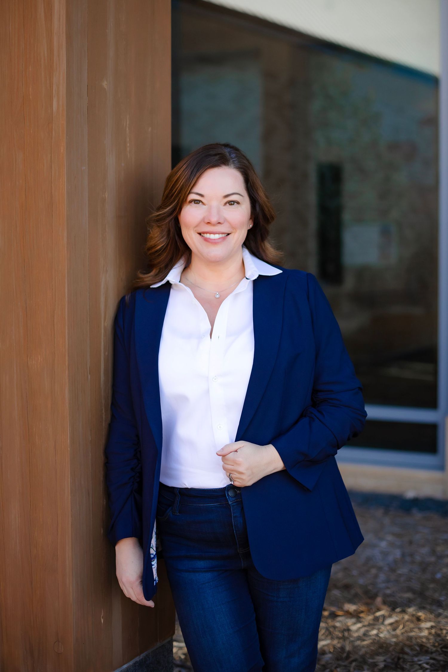 Business casual portrait featuring navy blazer and classic white shirt combination.