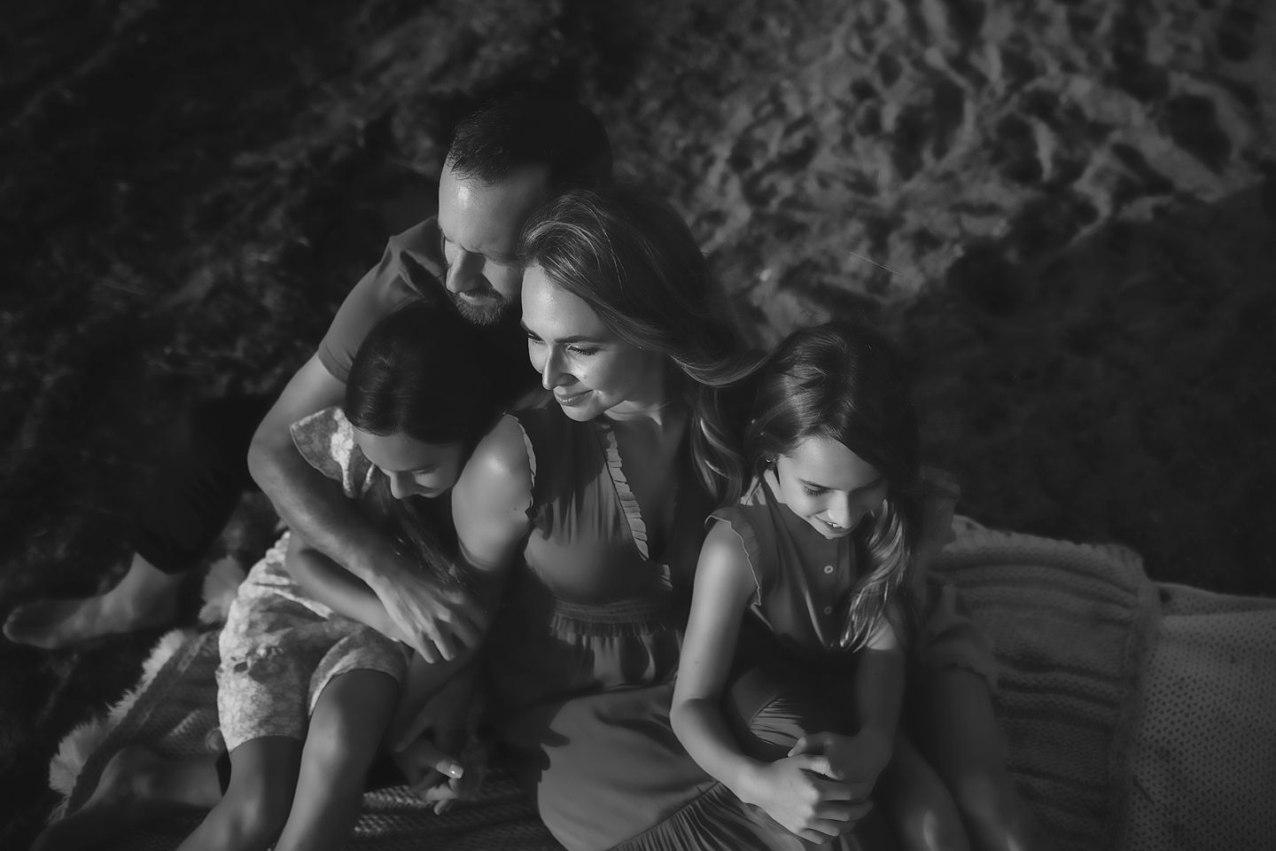 Intimate black and white family moment captured in natural lighting.