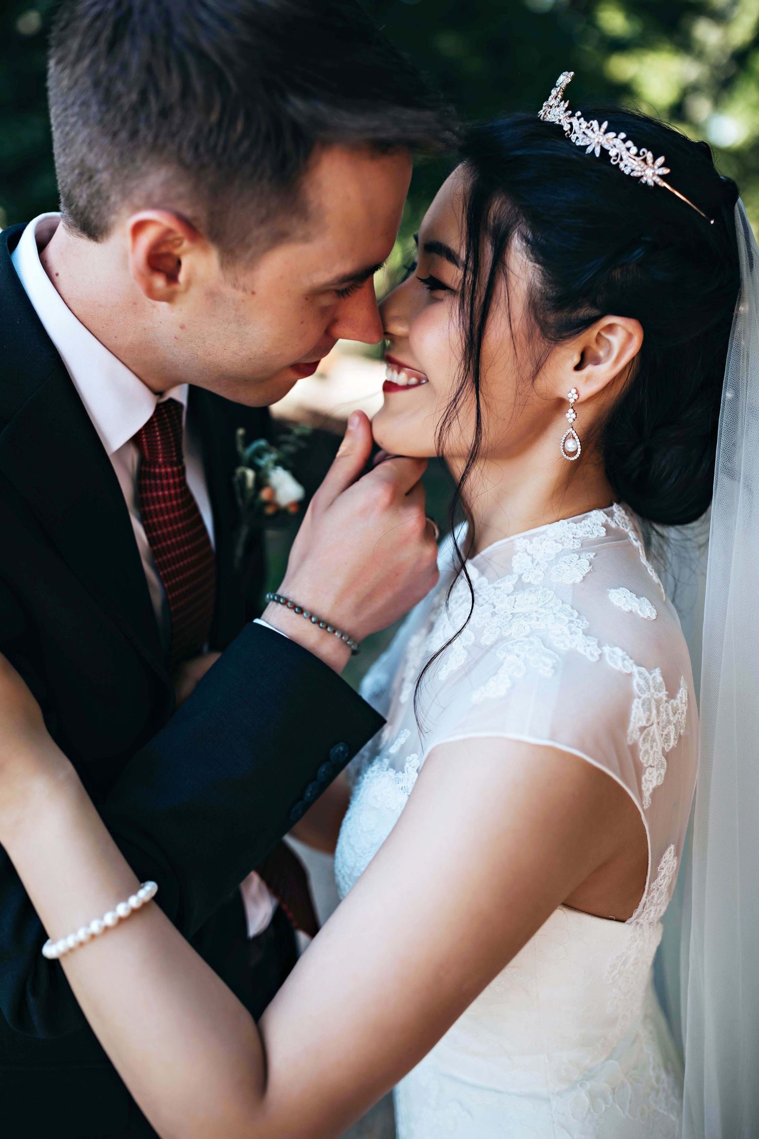 Intimate wedding portrait showing tender moment between couple in formal attire.