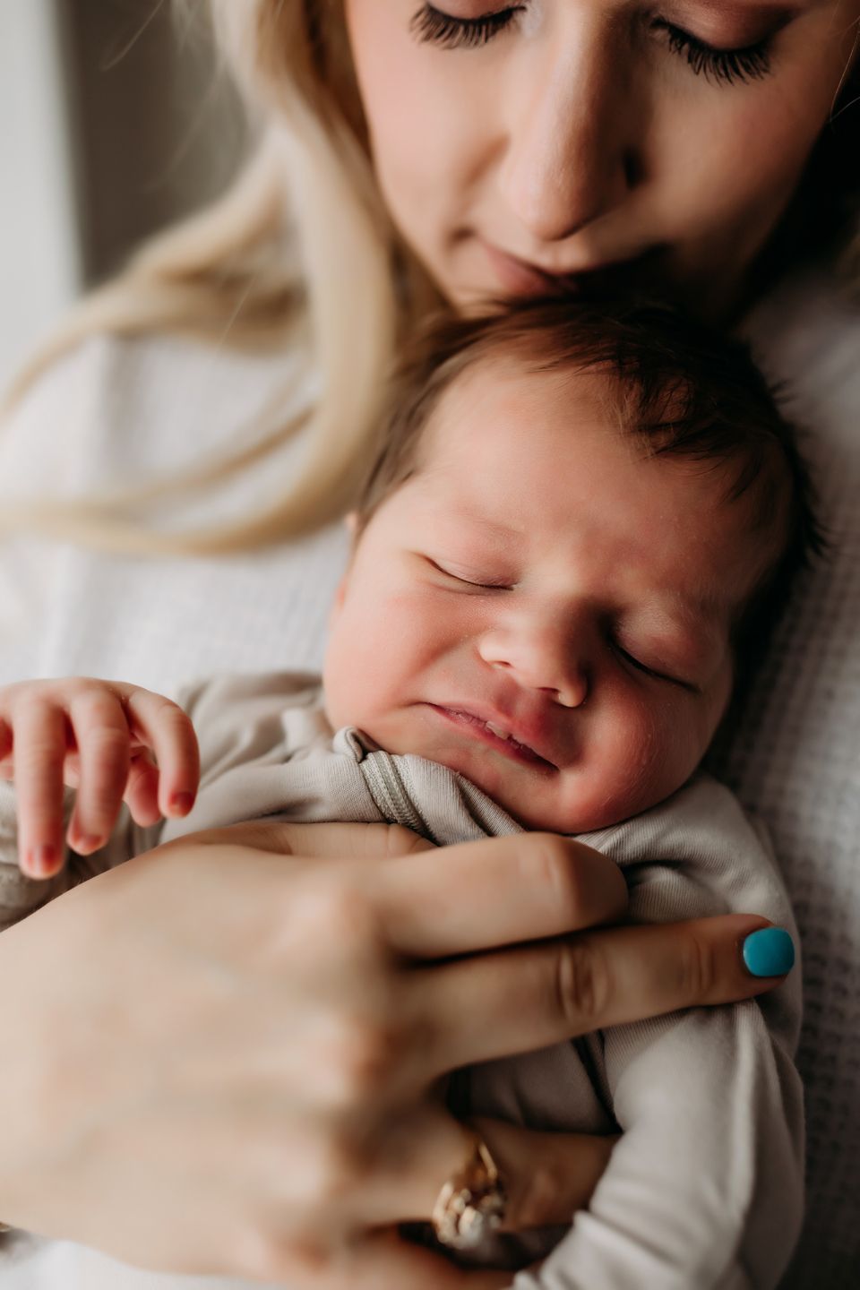 Close-up of peaceful sleeping infant being held.