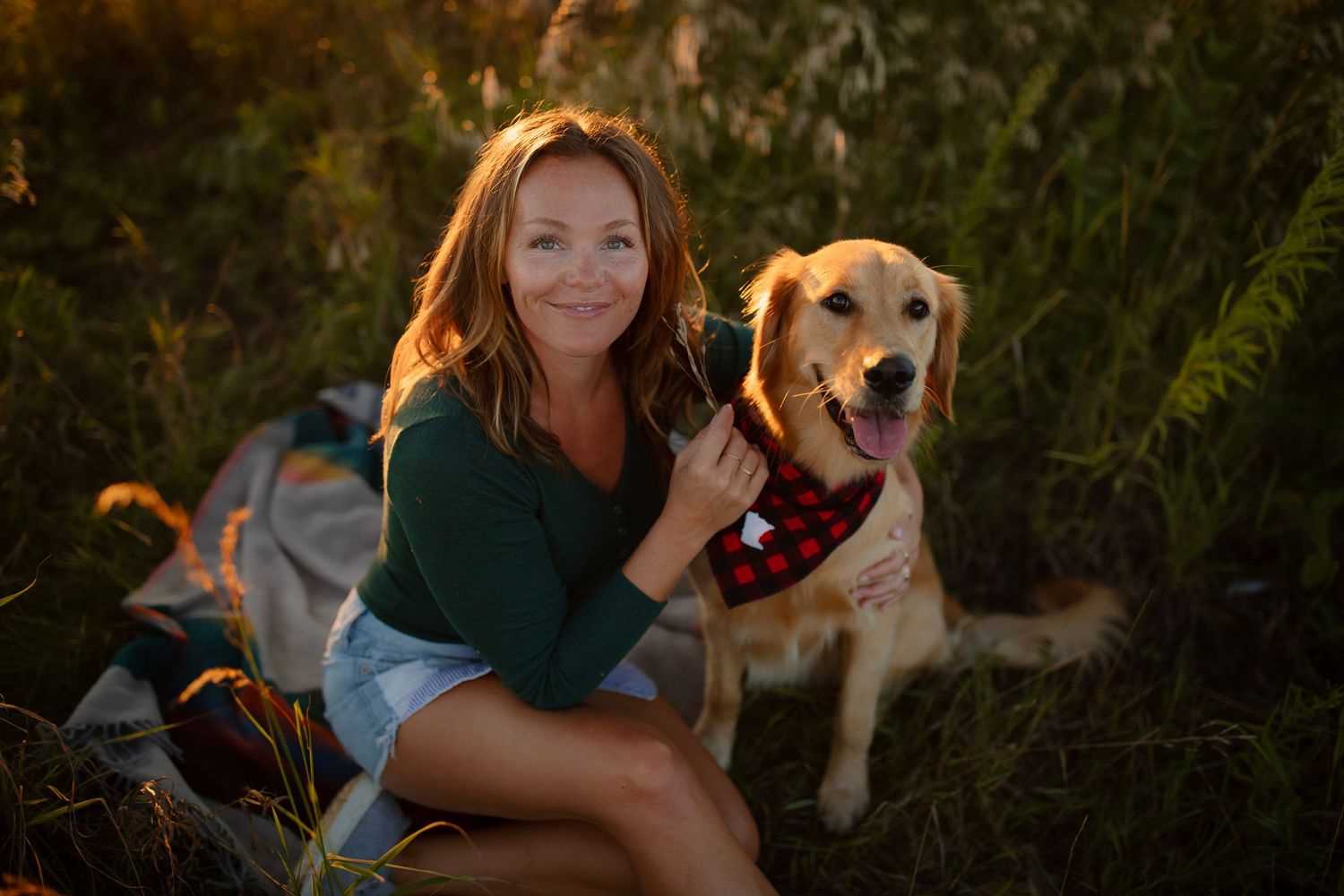 Happy golden retriever and companion enjoying a sunny autumn day outdoors.