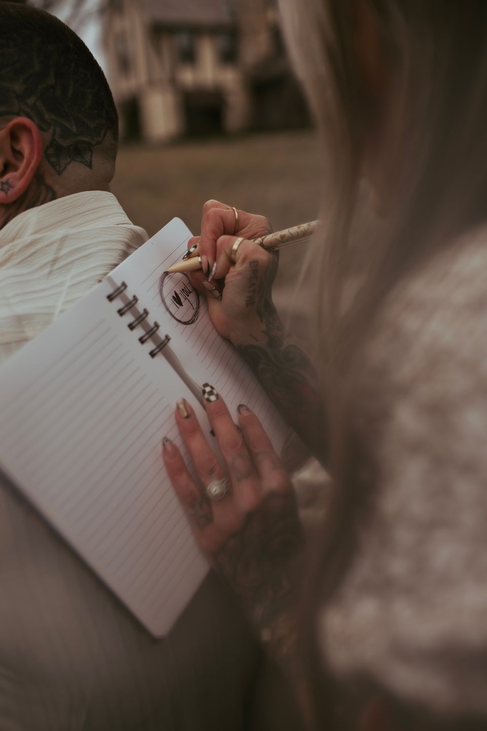 A person's hand writing in a white lined notebook with a pen, shown in a series of cropped views.