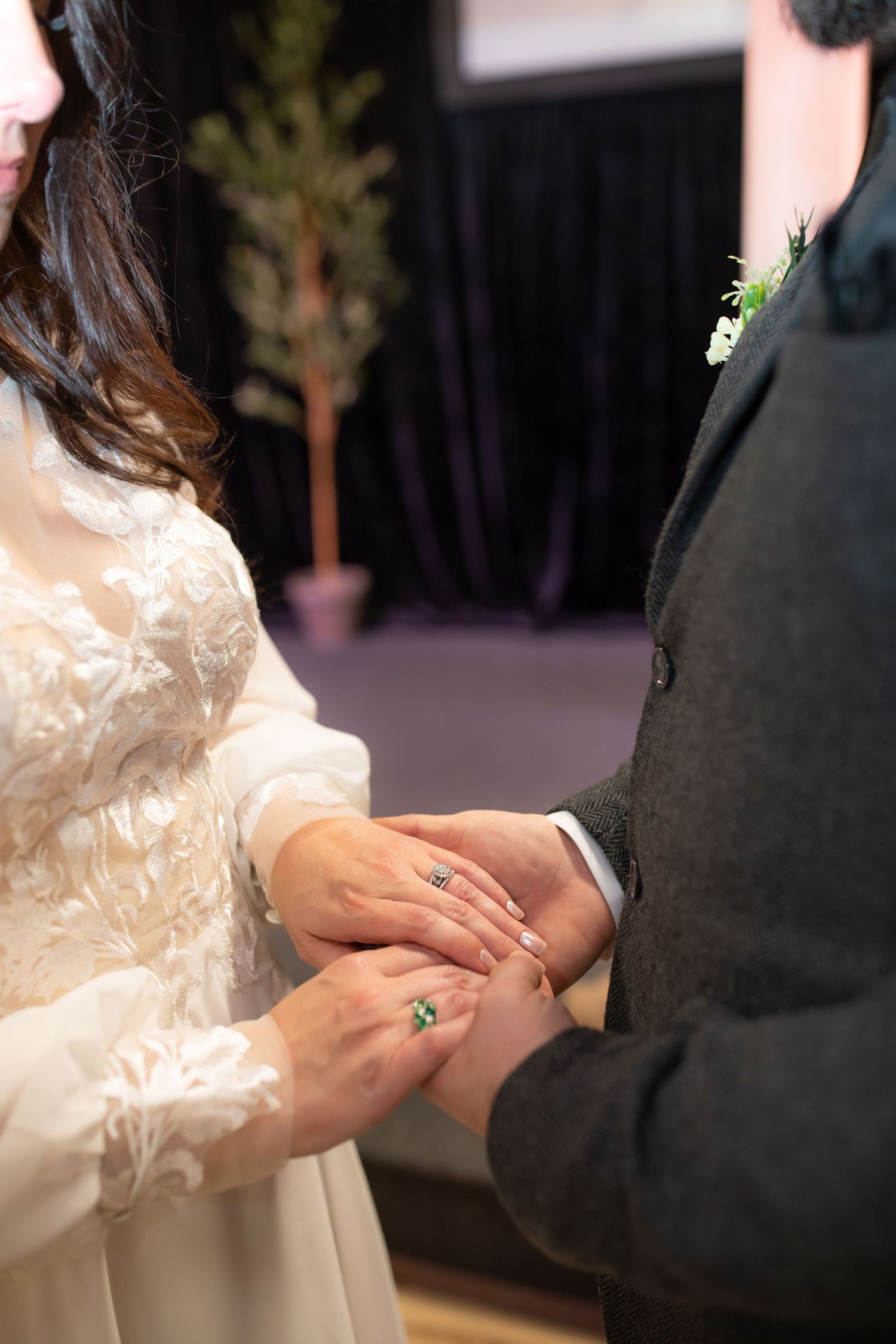 Close up of hands exchanging rings during wedding ceremony.