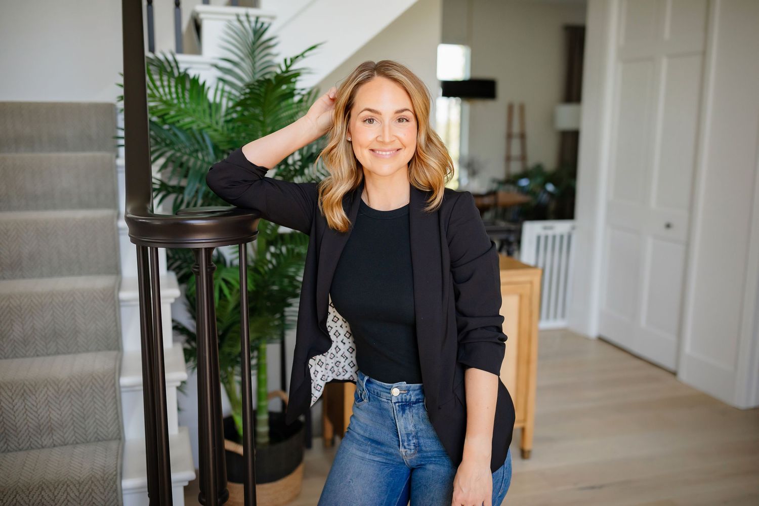 Casual lifestyle photo near stairway with indoor plants and modern home decor.