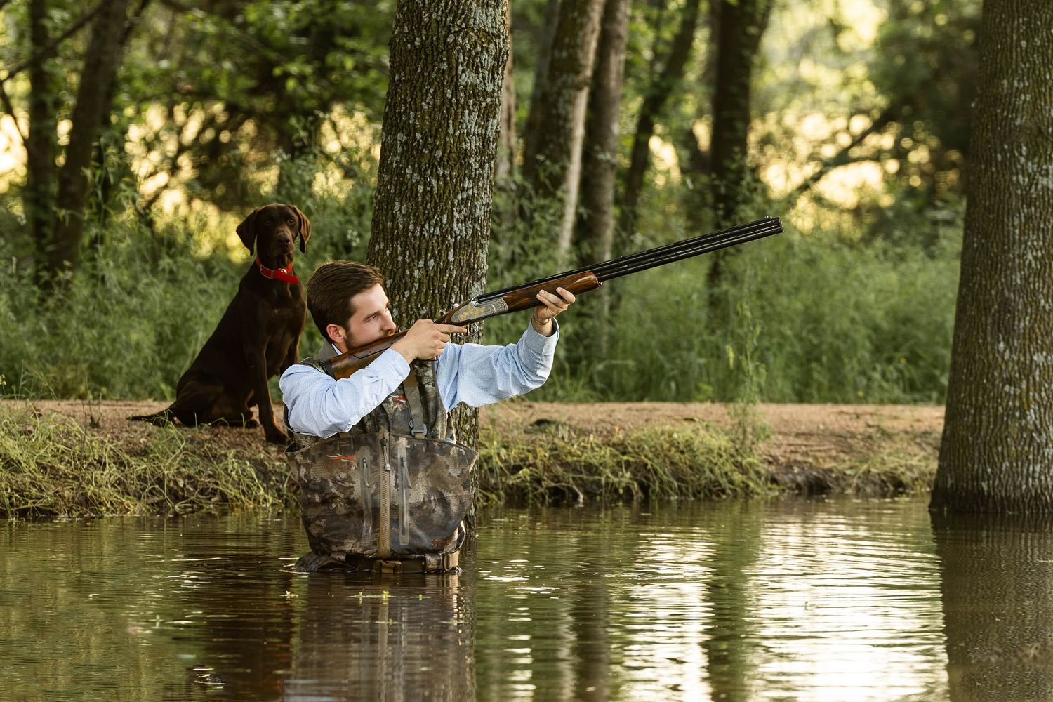 A serene fishing scene by the water's edge in natural lighting.