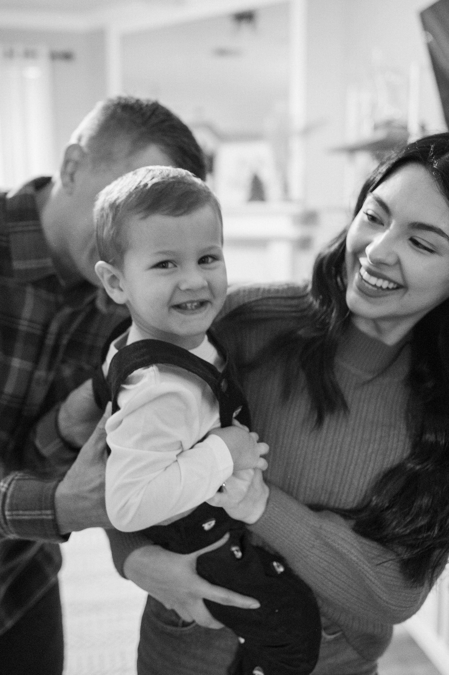 A joyful black and white portrait of a family sharing a laugh together.