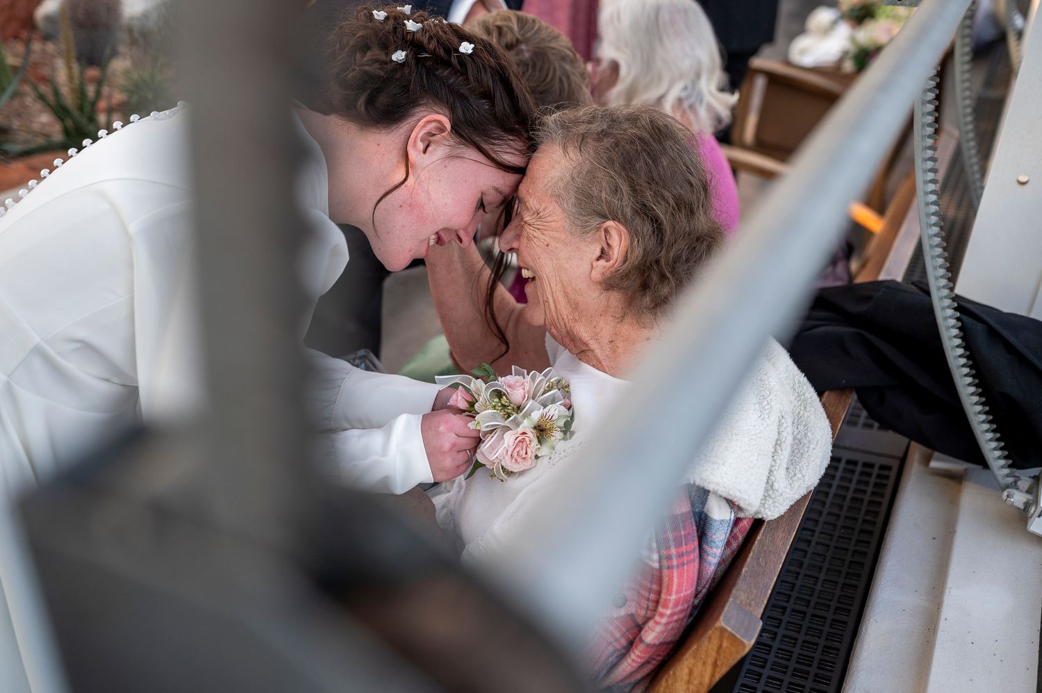 A tender moment captured between two people during what appears to be a celebration or event.