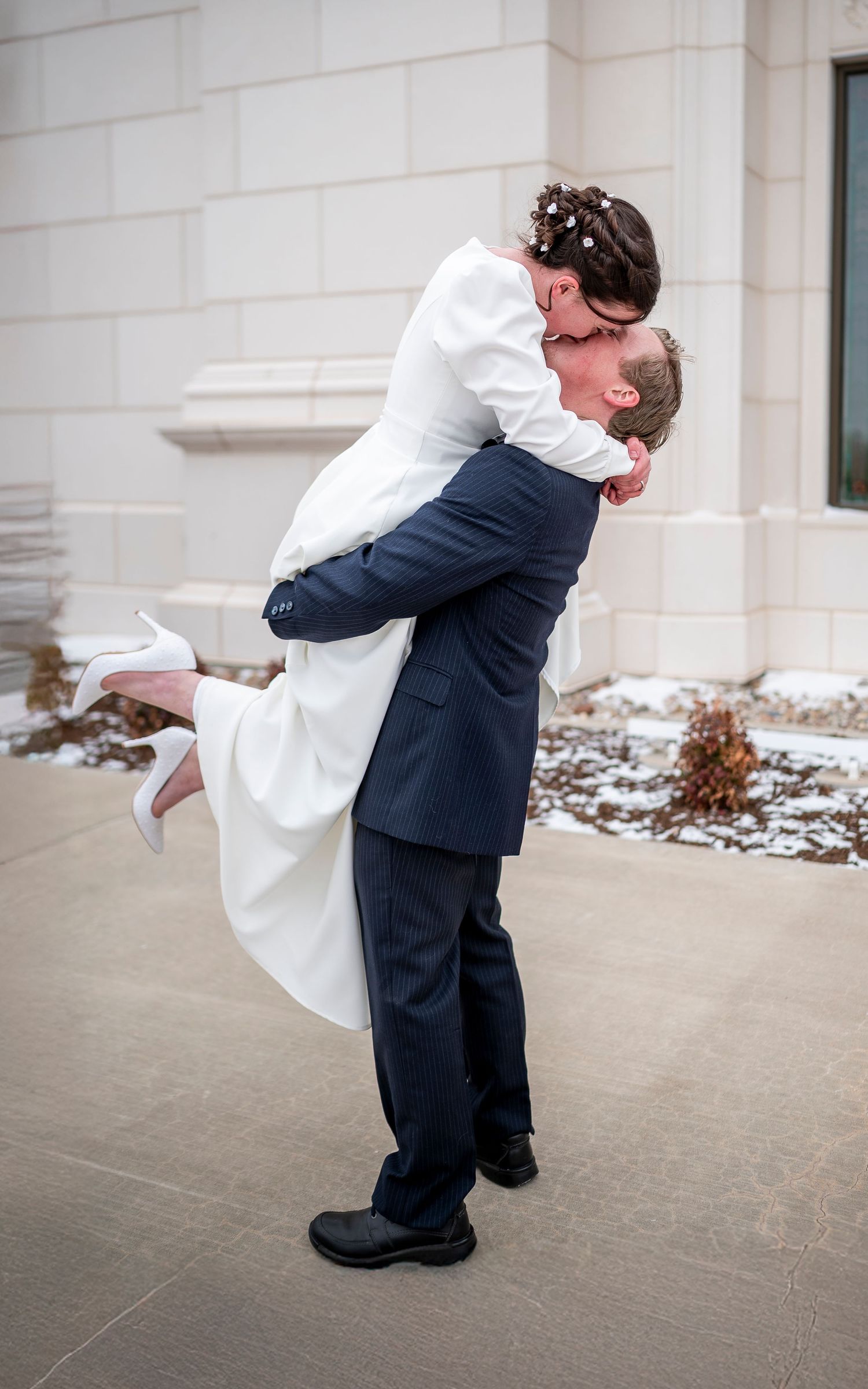 A joyful wedding lift pose showing movement and energy between the couple on their special day.