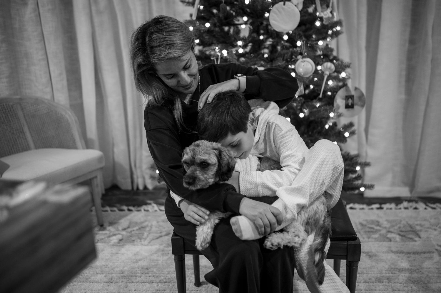 A tender black and white portrait with a small dog during Christmas time.