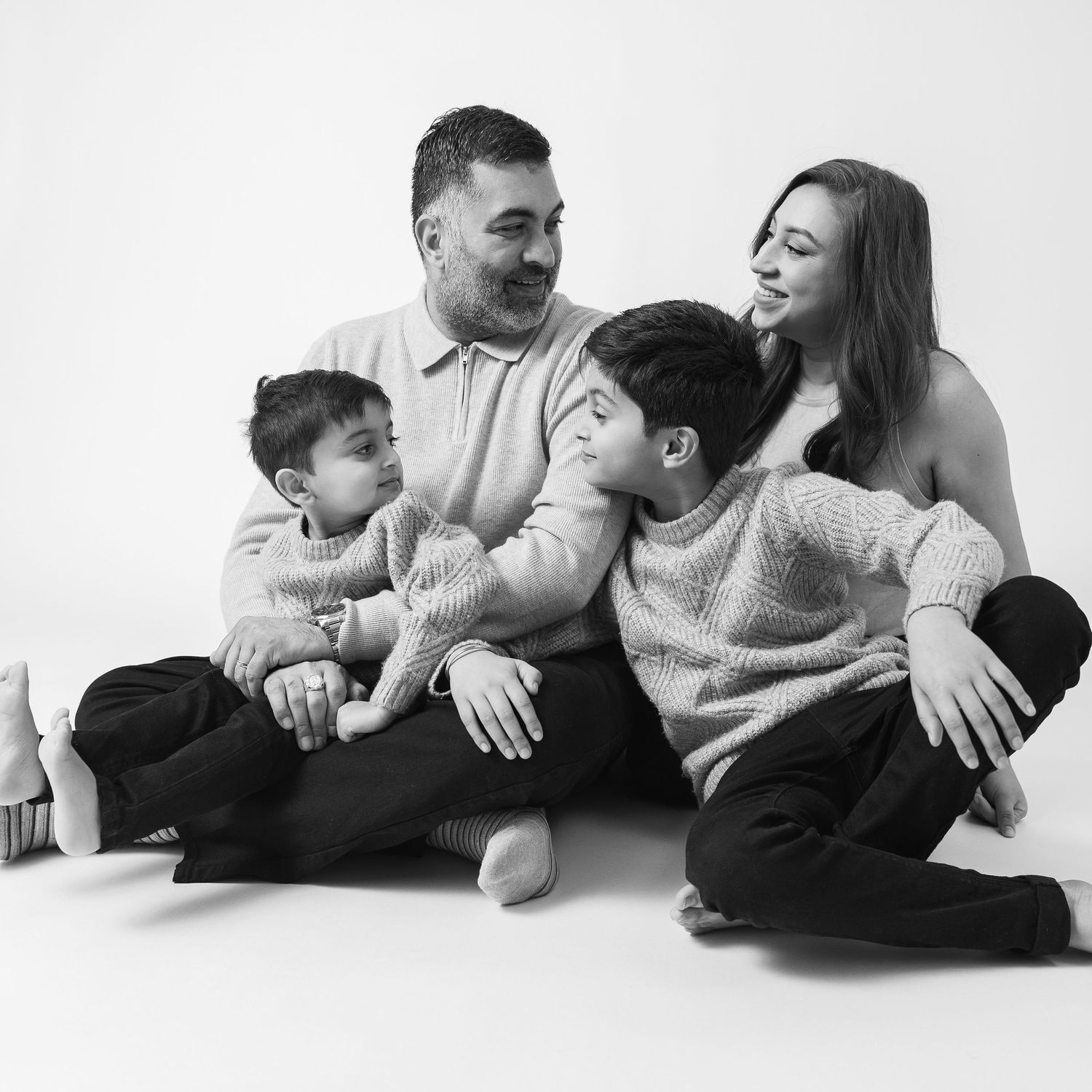 Black and white family portrait session showing casual loving moments.