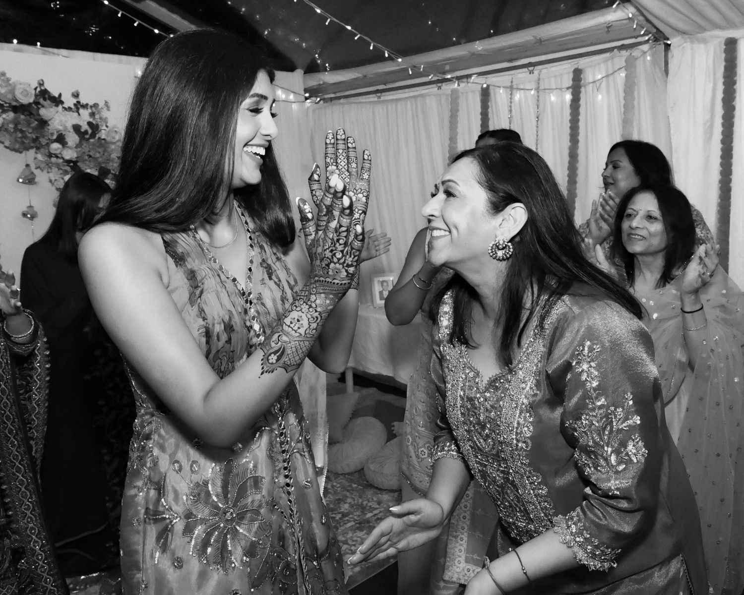Wedding party guests dancing and celebrating in formal attire.