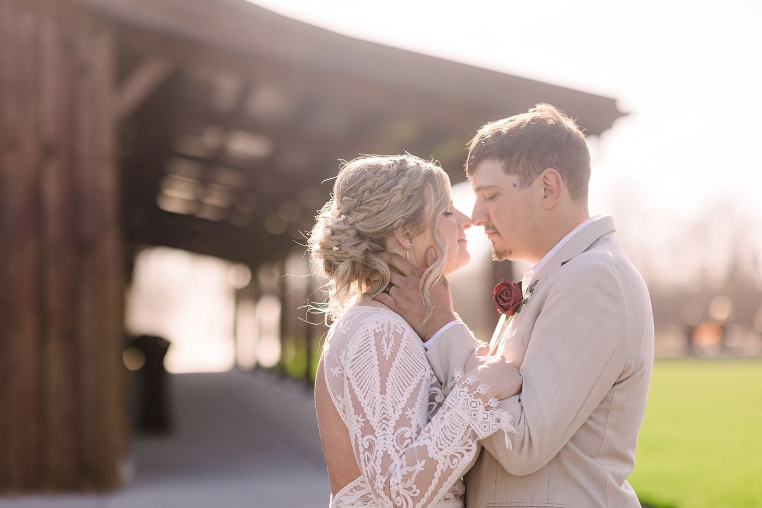 Bride and groom share intimate moment nearly kissing in golden sunset light outside Hanover Reserve.