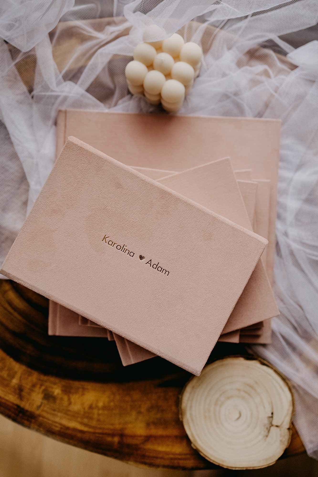 Blush pink velvet wedding photo album boxes personalized with Karolina and Adam names.