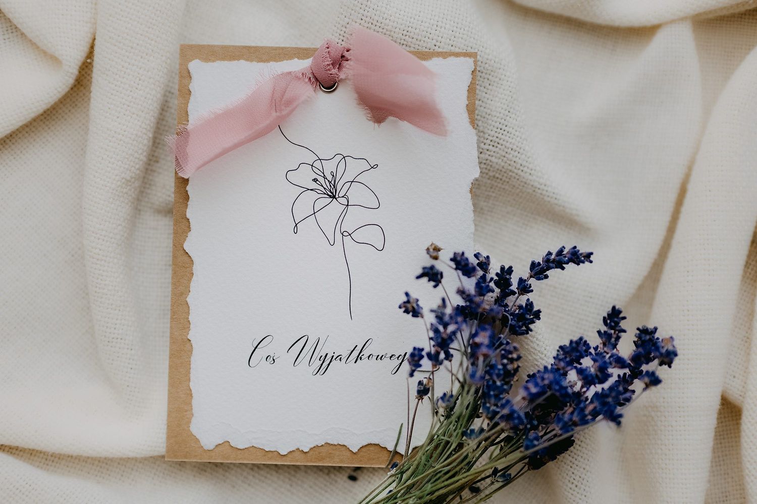 Elegant gift card with lily flower illustration and lavender bouquet on kraft paper with pink ribbon.