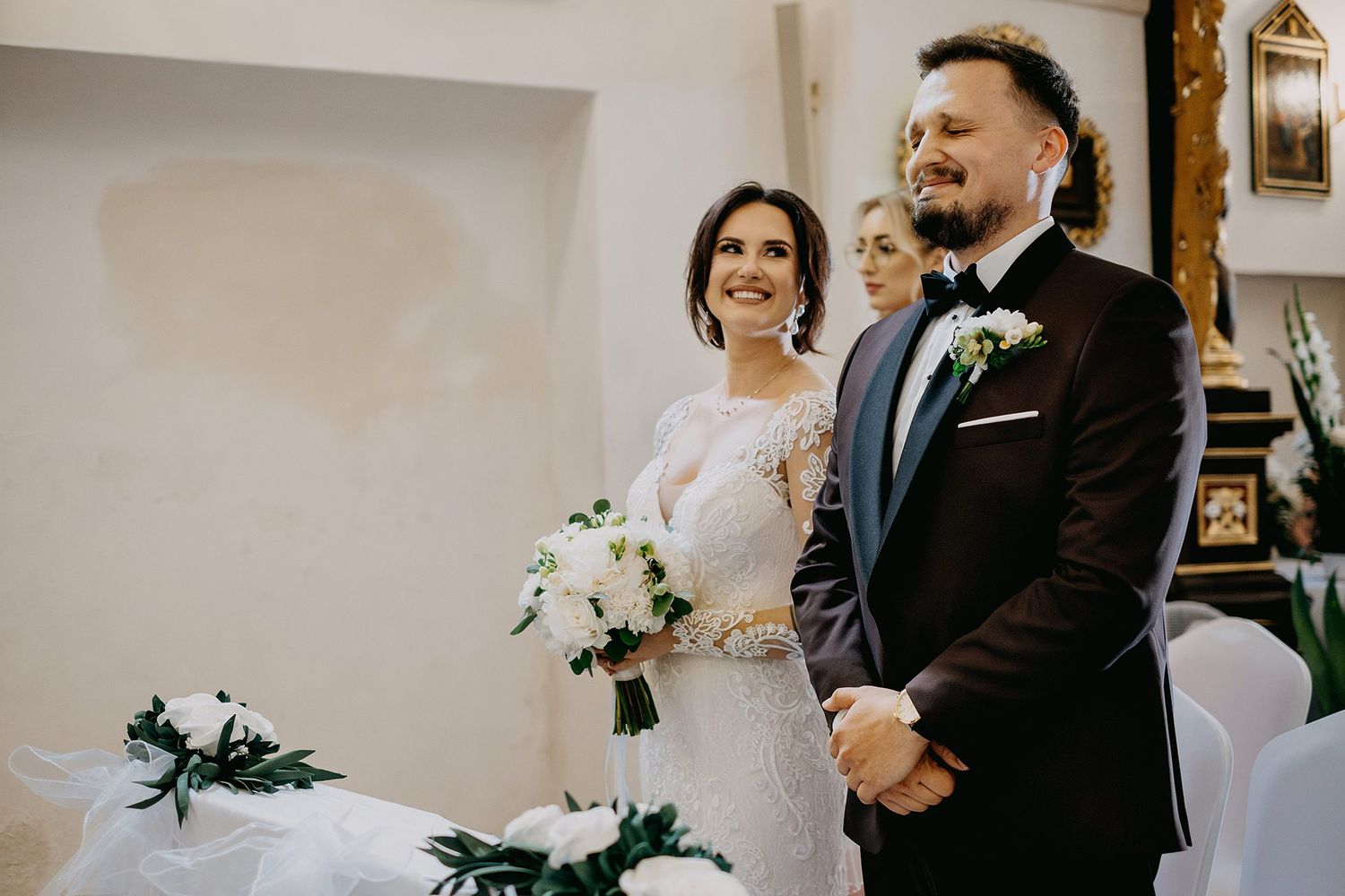 Bride and groom standing at the altar during their wedding ceremony indoors.