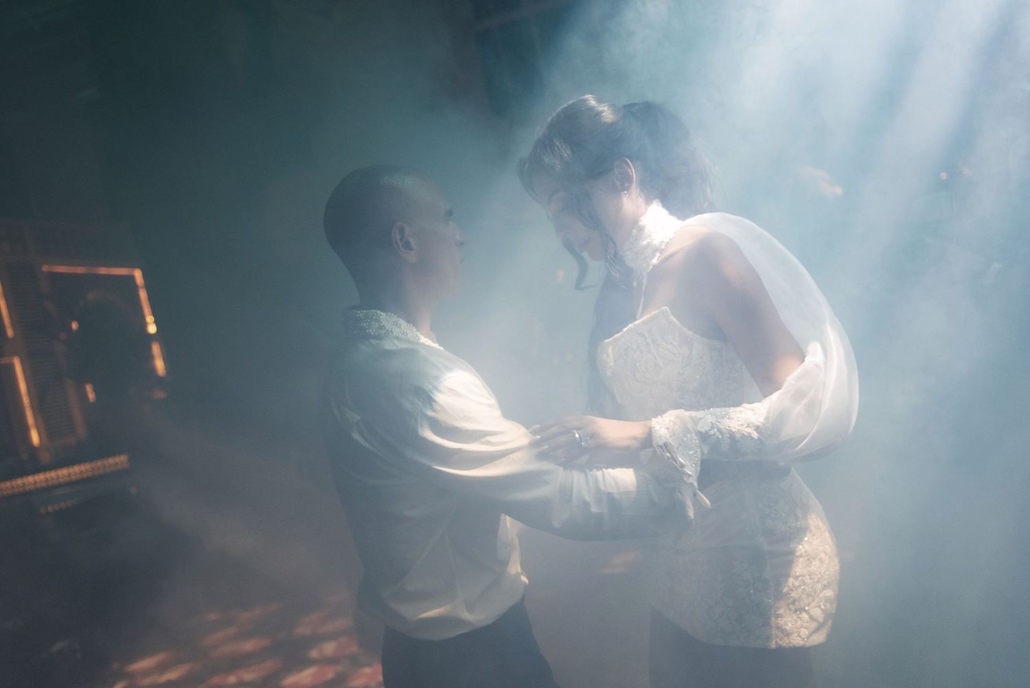 Couple sharing intimate dance moment in dramatic smoky atmospheric light indoors. Dominican Republic