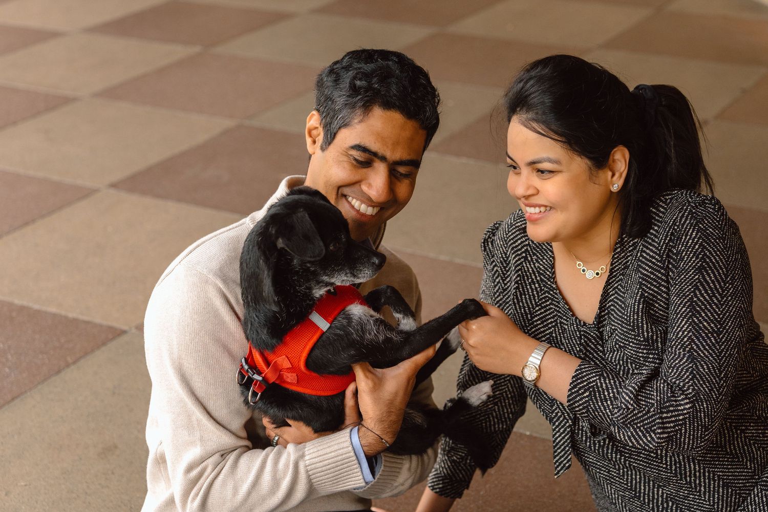 mom and dad holding their pup in Stanford University