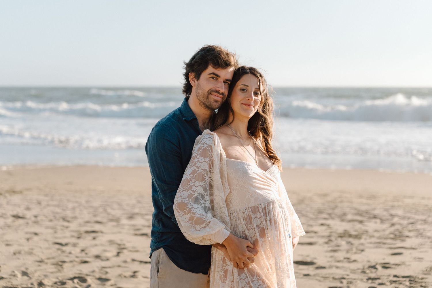 parents to be with bay area beach background during golden hour maternity photo session in Daly City