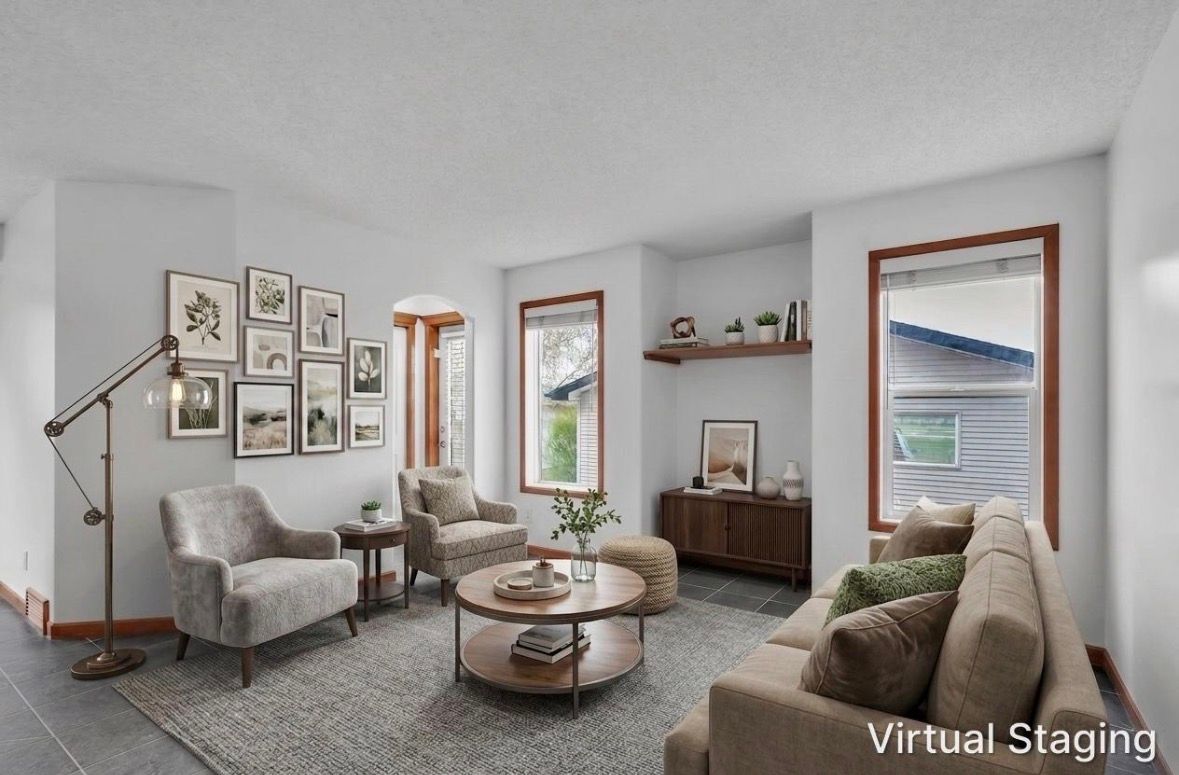 Virtually staged living room with gray sofas, gallery wall, wood furniture, and natural window light.
