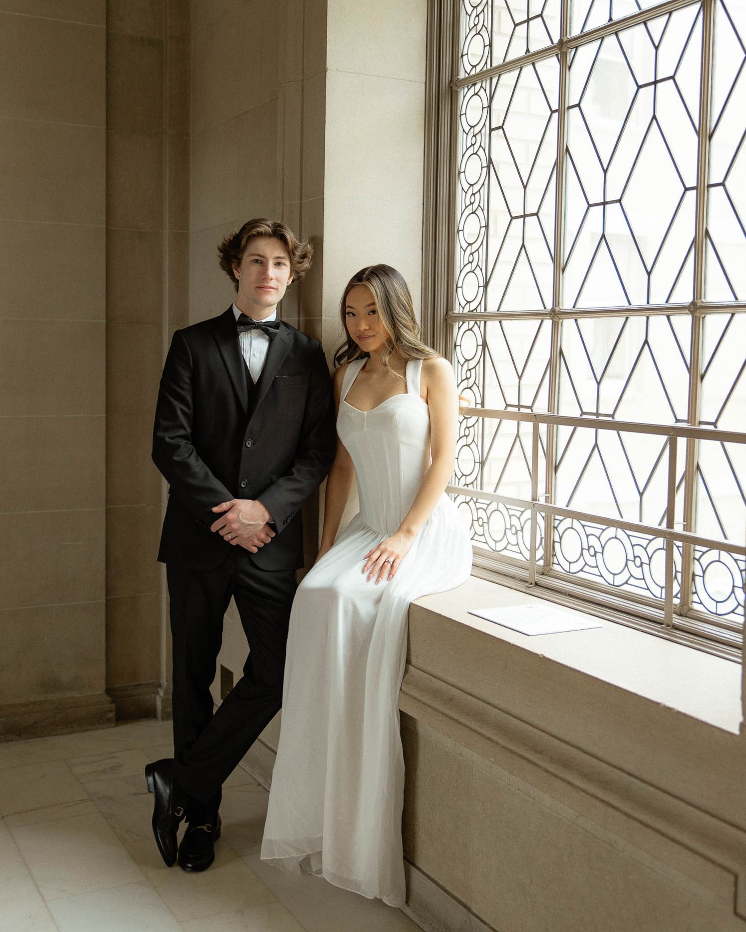 Bride and groom posing indoors during a timeless wedding photography session in San Francisco City Hall California.