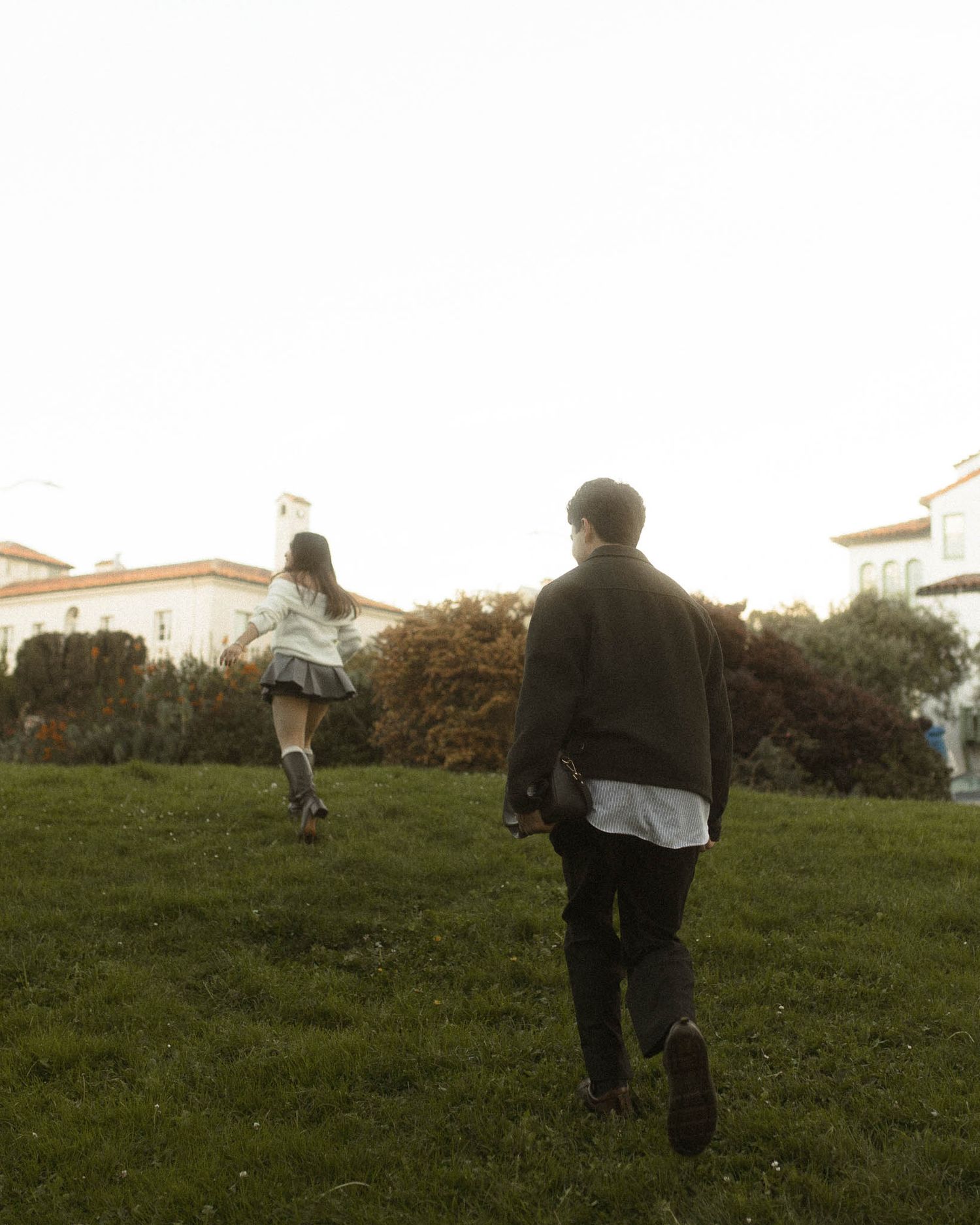 Couple walking hand in hand  during a romantic engagement photoshoot in the Bay Area.