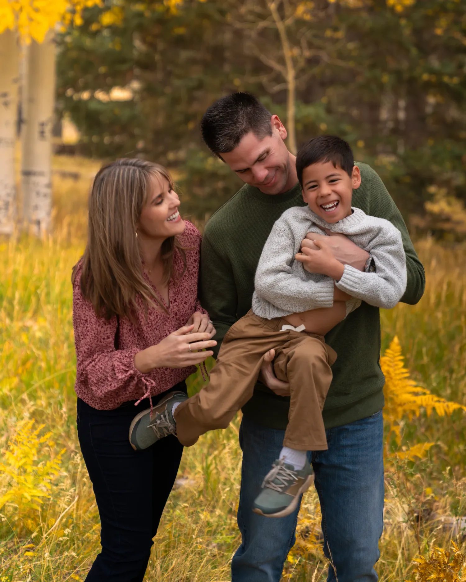 Family laughing during a fall family photography session at Aspen Corner near Snowbowl in Flagstaff, Arizona