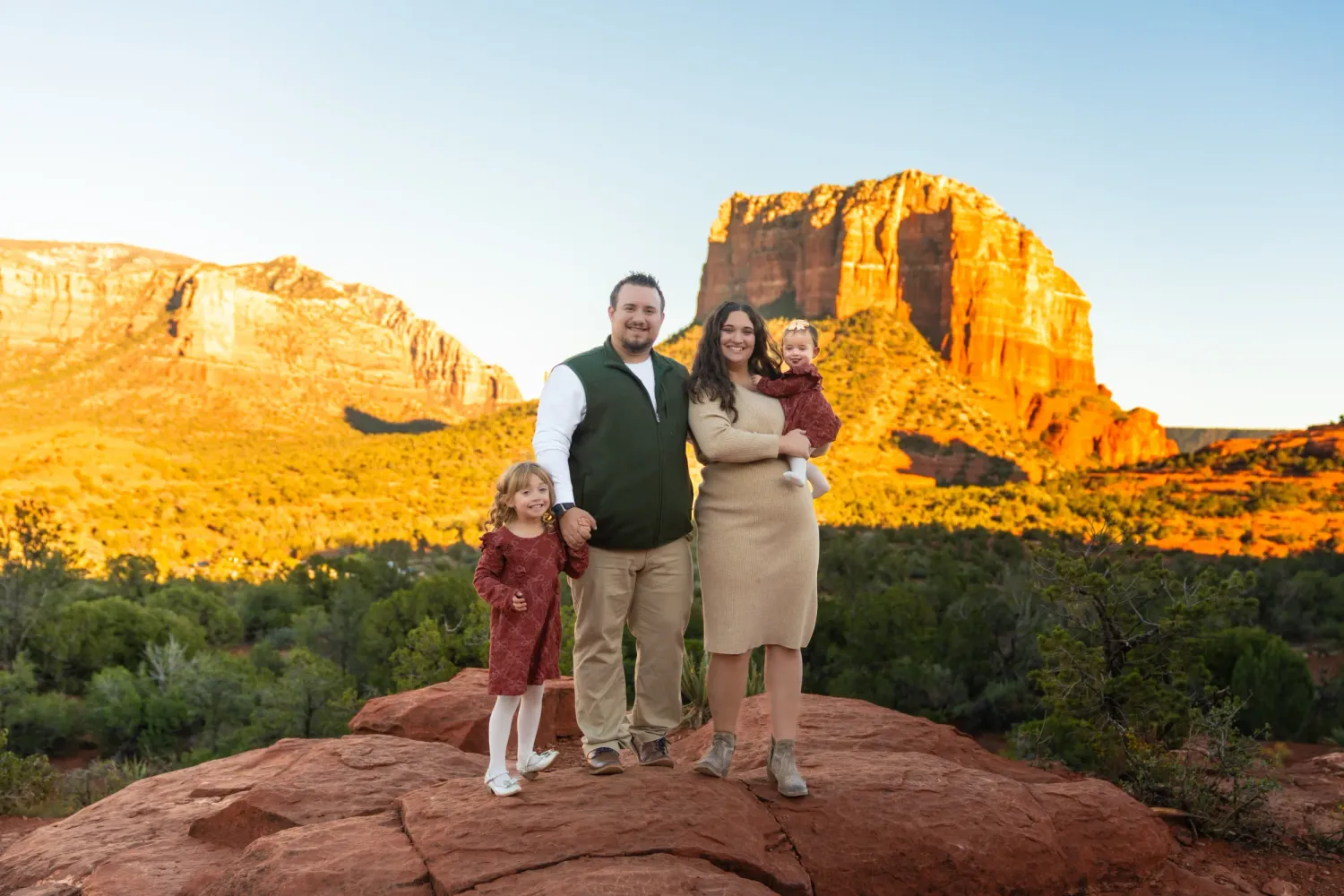 Family of four portraits at Yavapai Vista in Sedona, Arizona with red rock views at golden hour.
