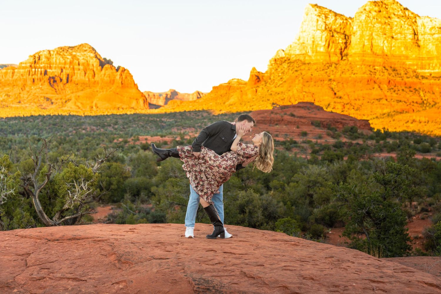 Stunning red rock formations glowing orange at sunset in Sedona Arizona.