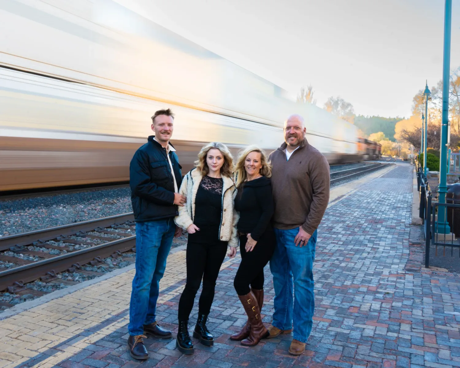 Family portraits with a passing train creating motion blur in downtown Flagstaff, Arizona.