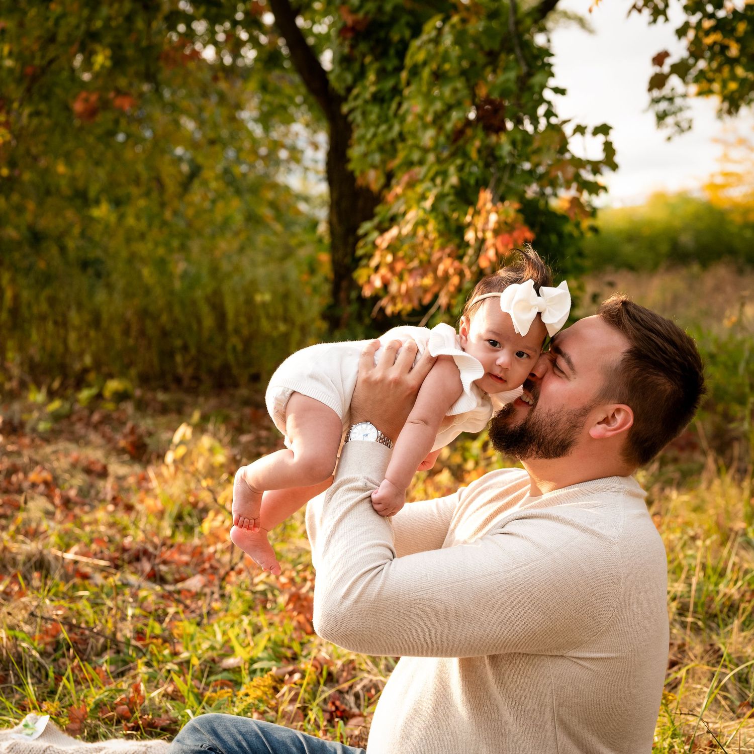 Candid moments captured during fall outdoor photo session with cream sweater.