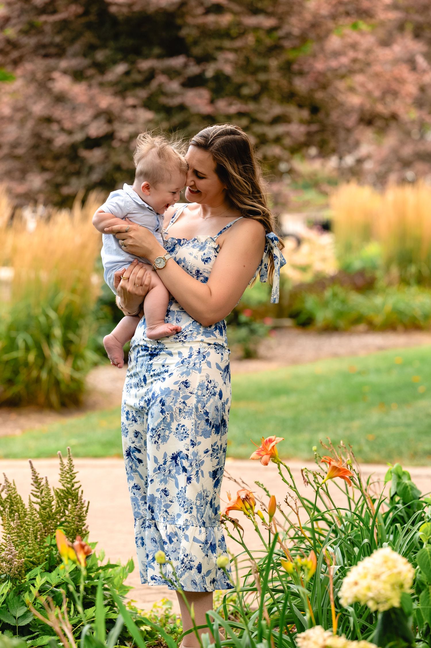 A tender moment in a flower garden with blue floral dress against warm autumn colors.