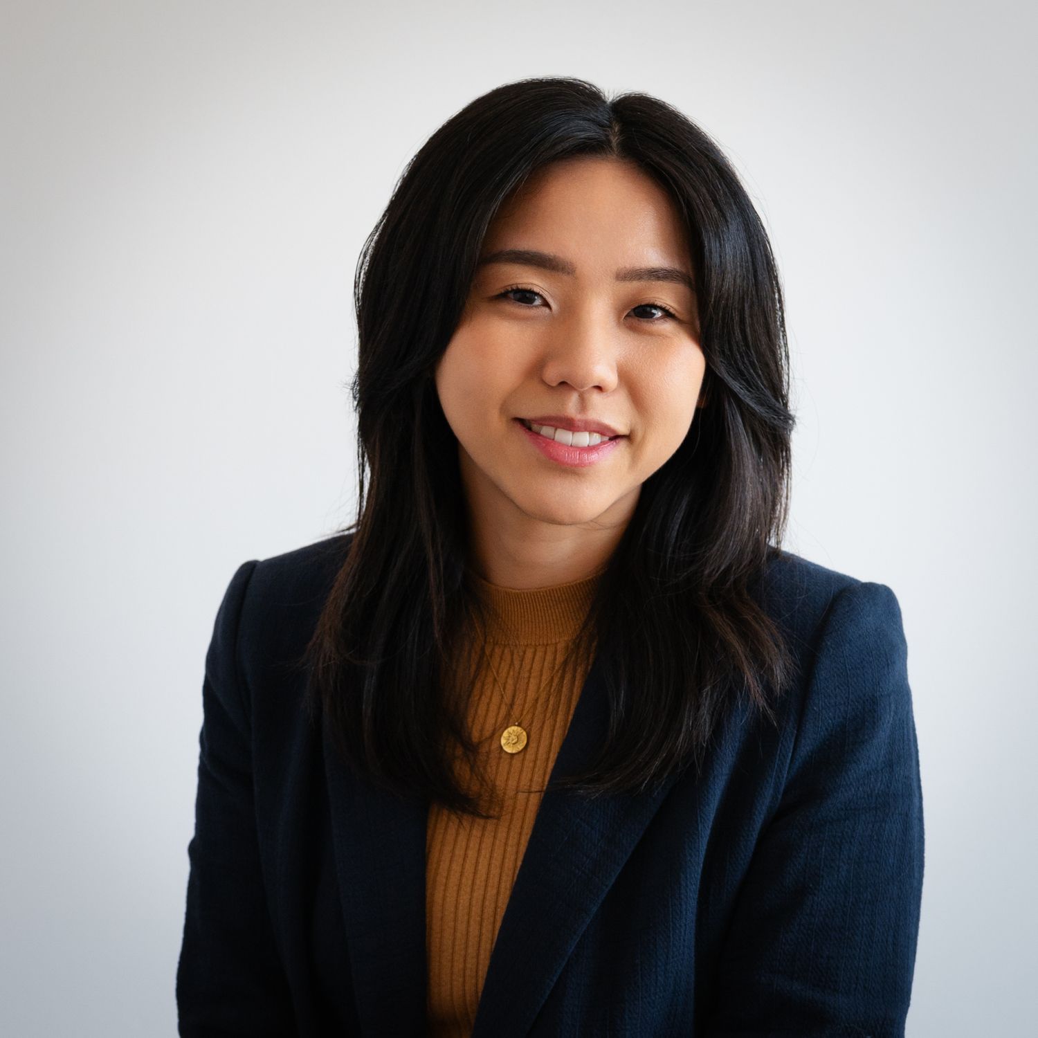 A professional headshot of a young woman.