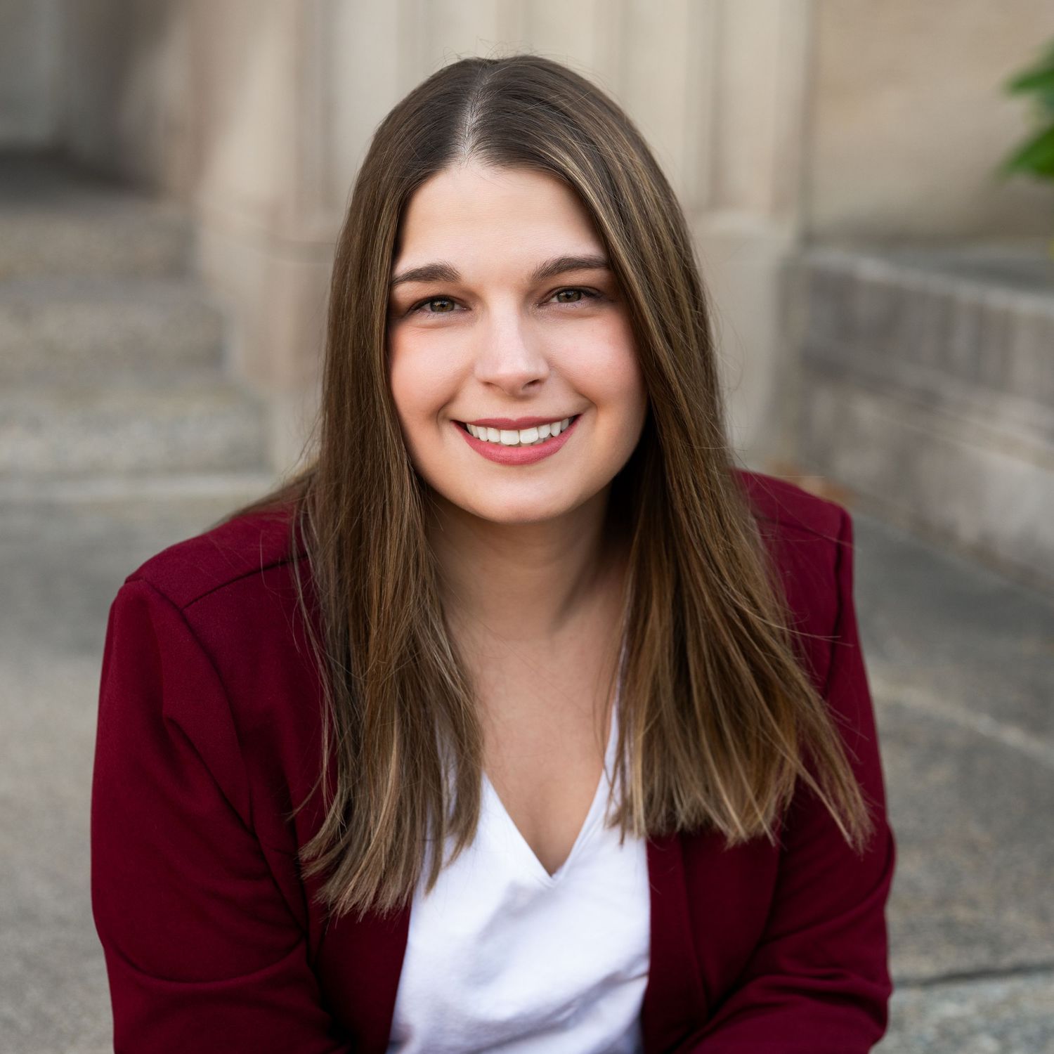 A professional headshot of a young woman.