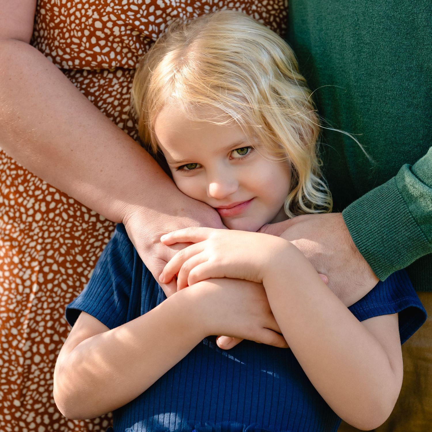 A close-up portrait showing gentle affection and warmth against autumn-colored clothing.
